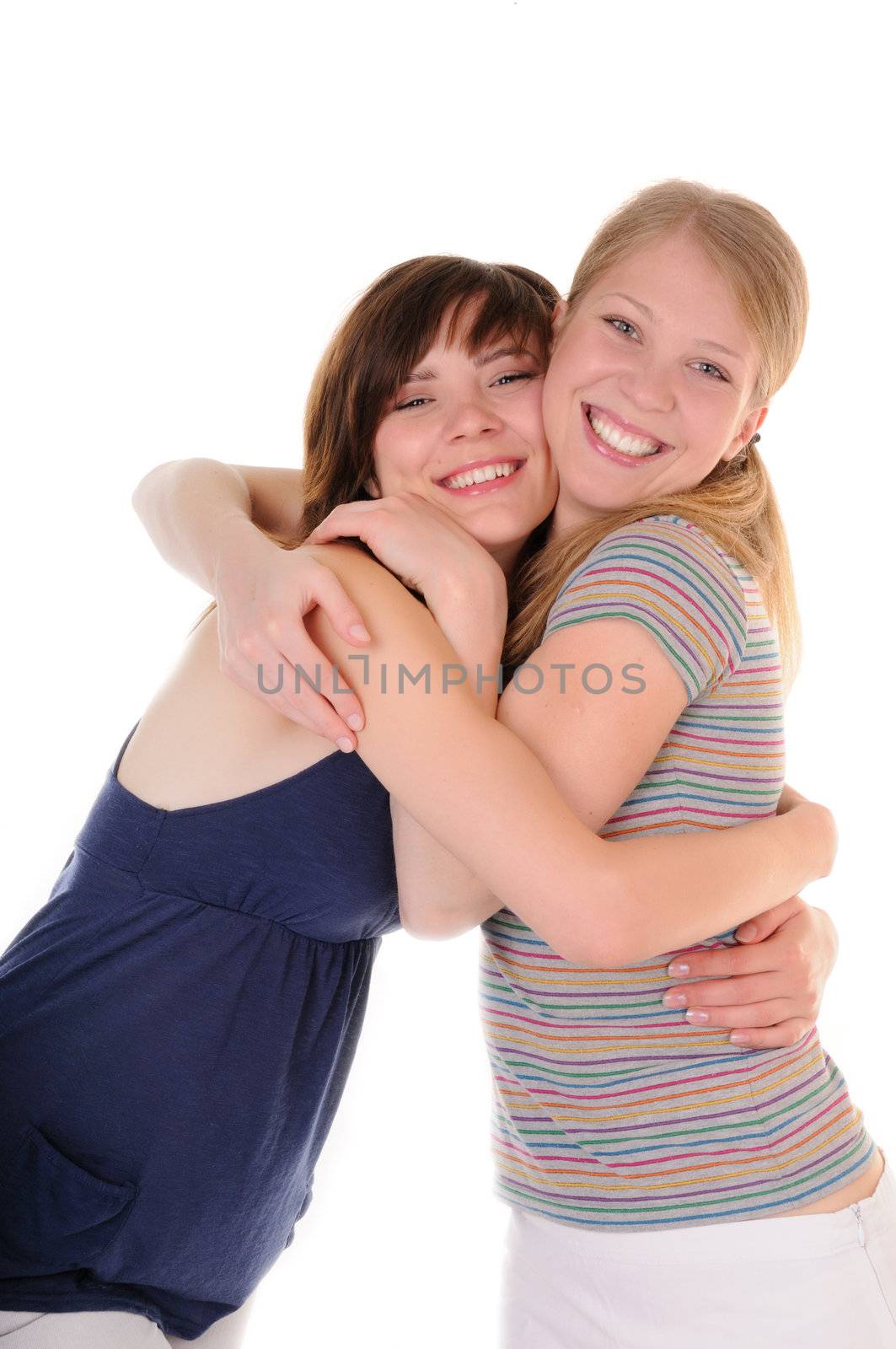 Two smilling girls are embraced on white background