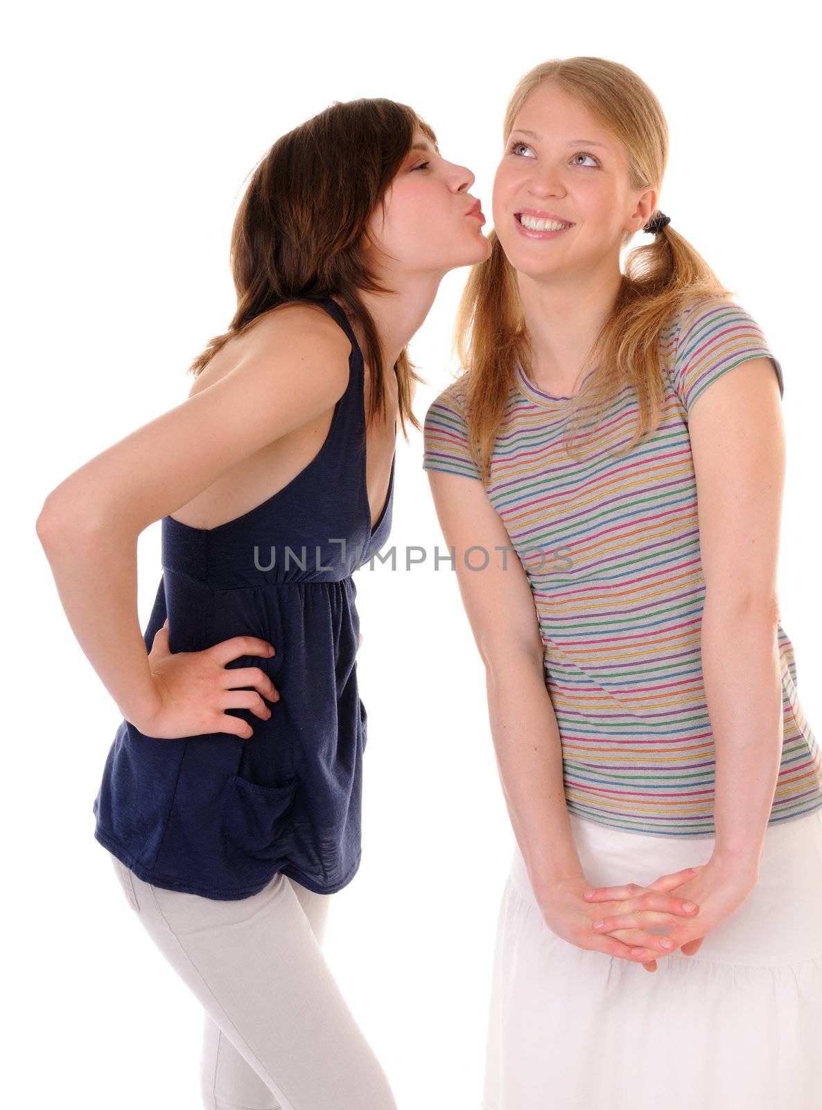 One young casual woman kiss in cheek another girl. Isolated on on white background.