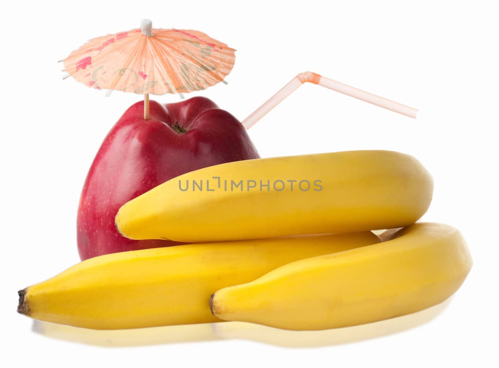 Bunch of fresh bananas and red apple with coctail umbrella isolated on white background. Shallow depth of field, forcus on apple.