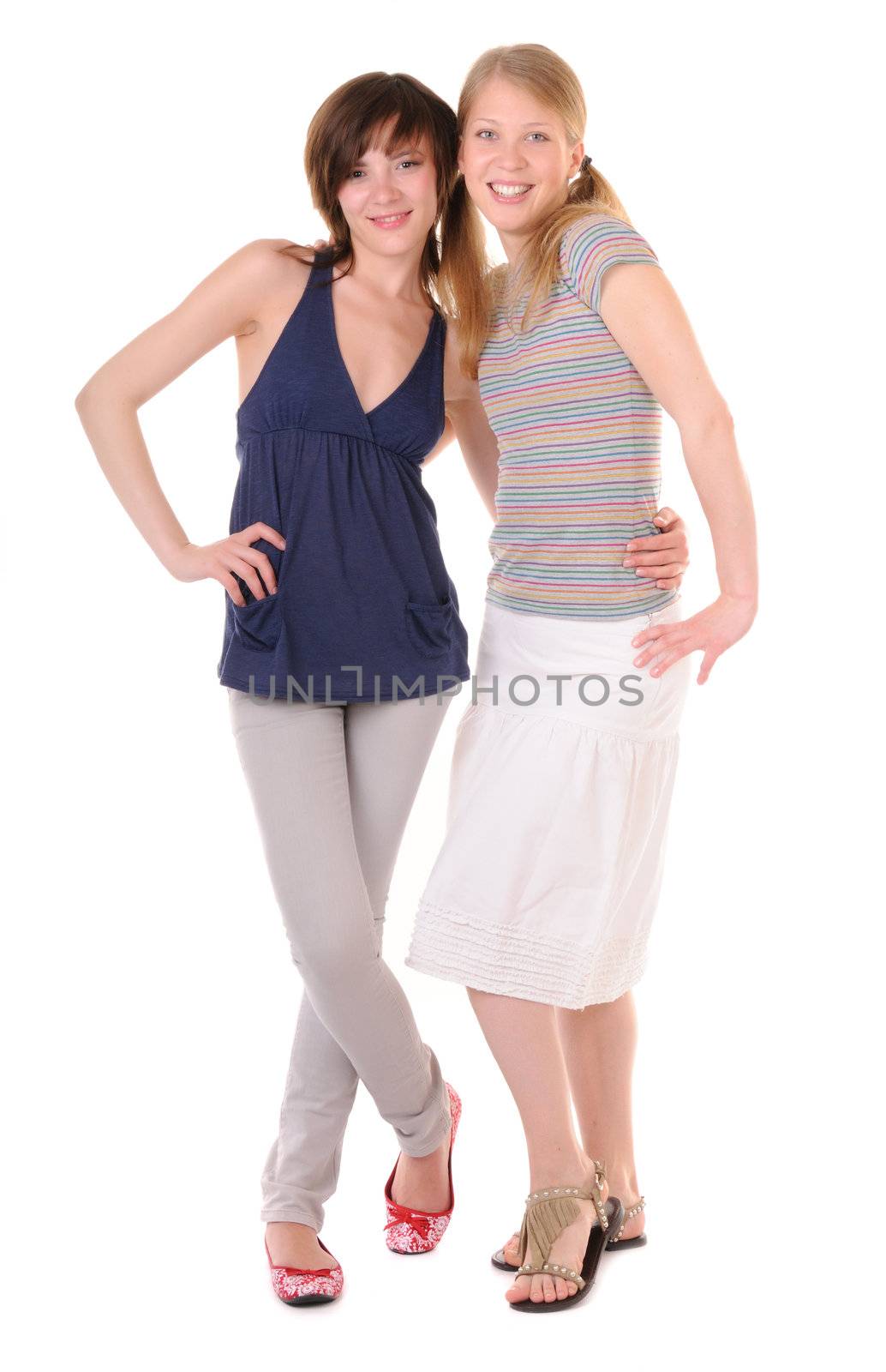 Two smilling girls are embraced on white background