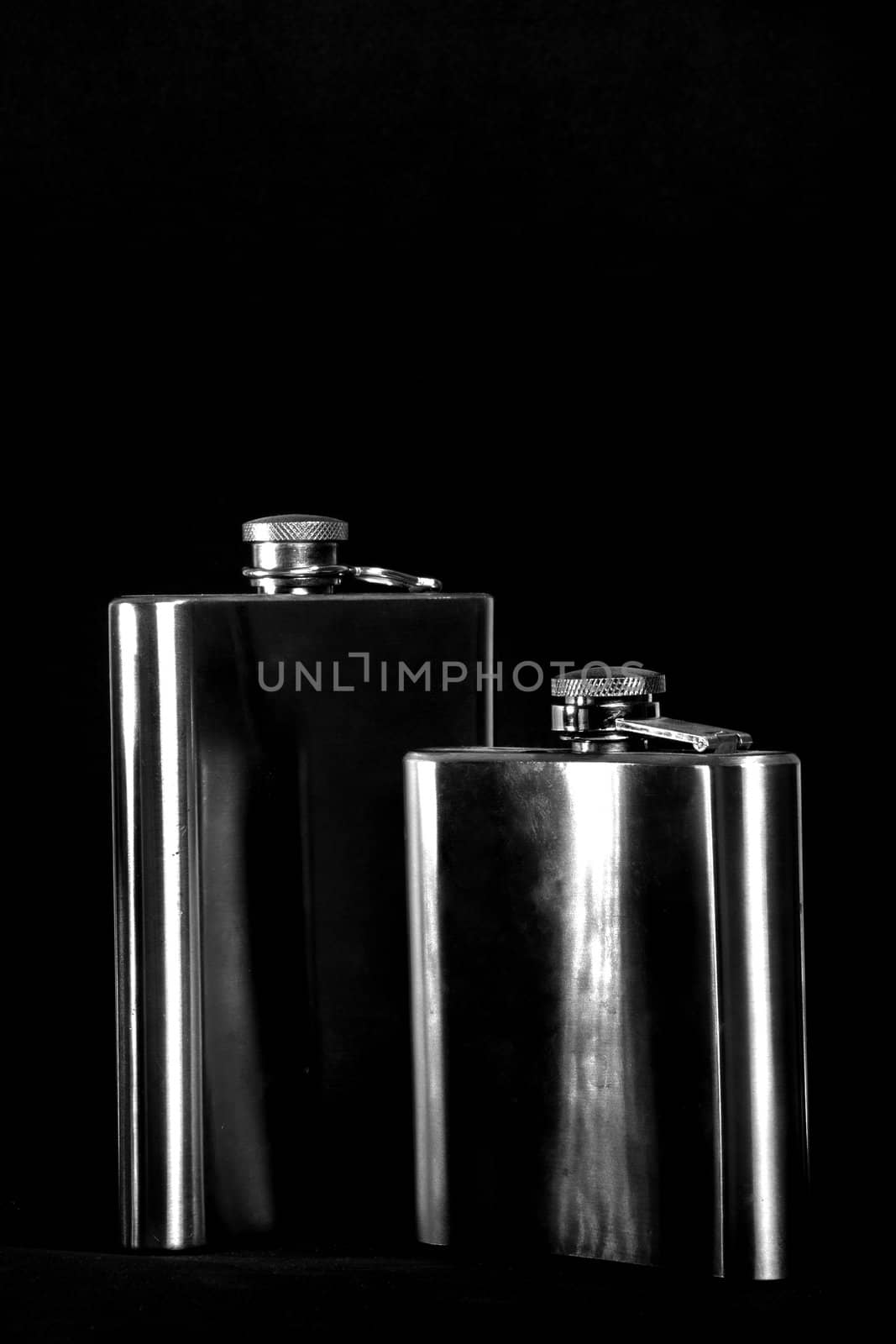 One of the most favorite men's toy - a metal flask for alcoholic beverages. Two used jars of stainless steel for whiskey or brandy