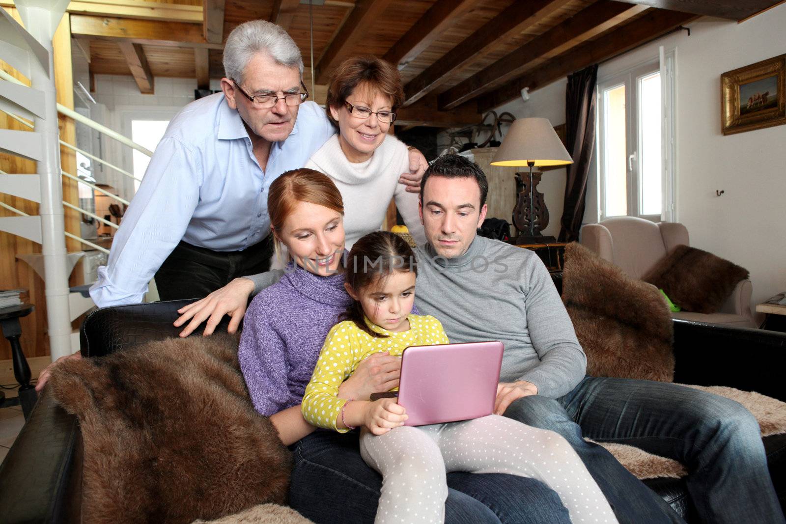 Whole family around a laptop