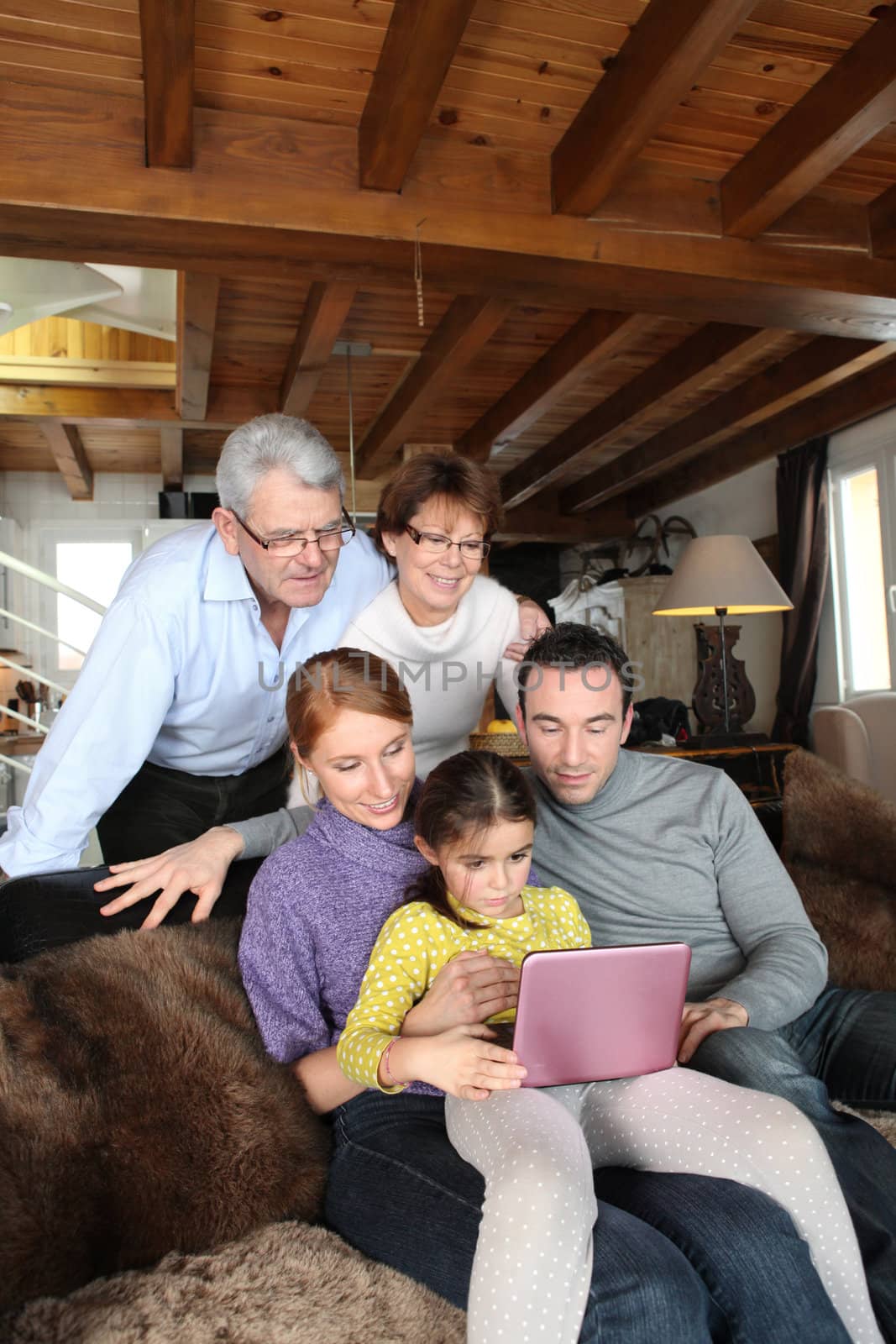 Family in front of a computer by phovoir