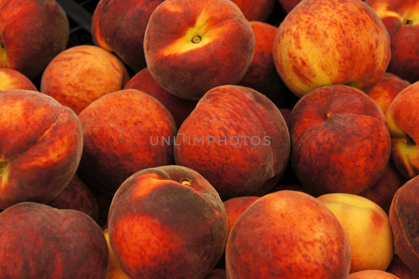 Heap of fresh  peaches on display at a market