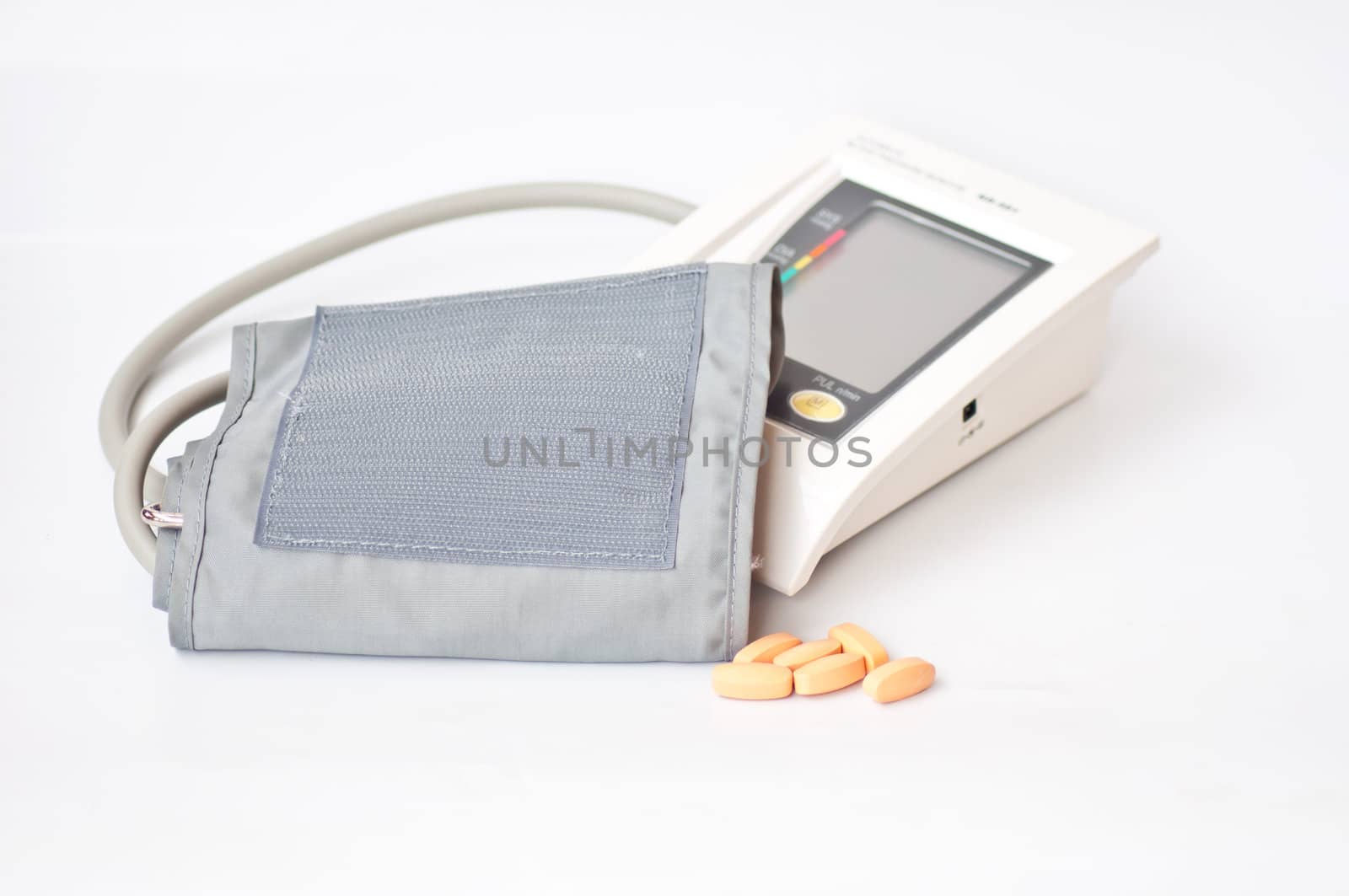 sphygmomanometer and drug on white background