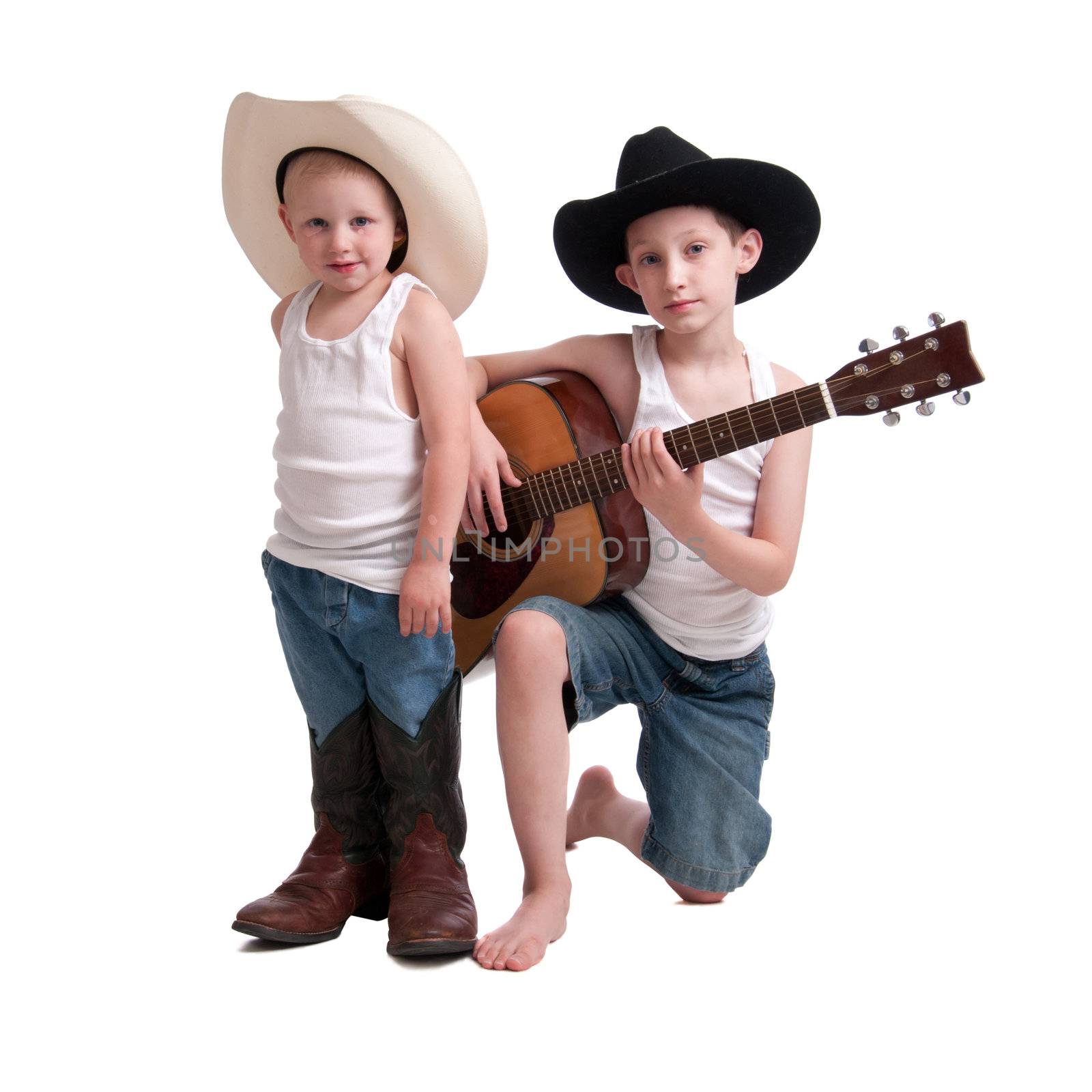 Two young brothers in cowboy hats and guitar