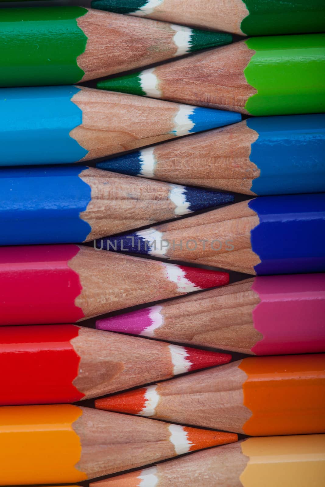 A vivid image with intersected colored pencils such as yellow, orange, red, pink and blue.