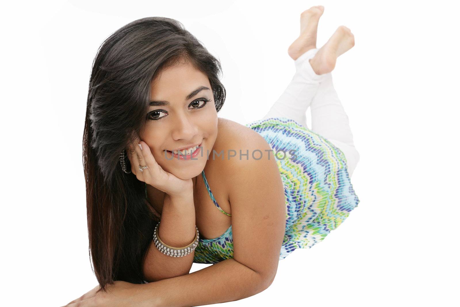 Portrait of a smiling young woman lying on the floor isolated on white background