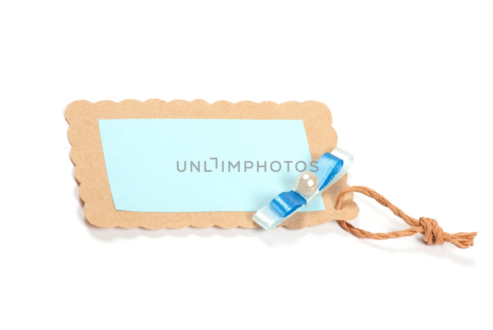 Blank tag tied with brown string. Price tag, gift tag, sale tag, address label, etc.