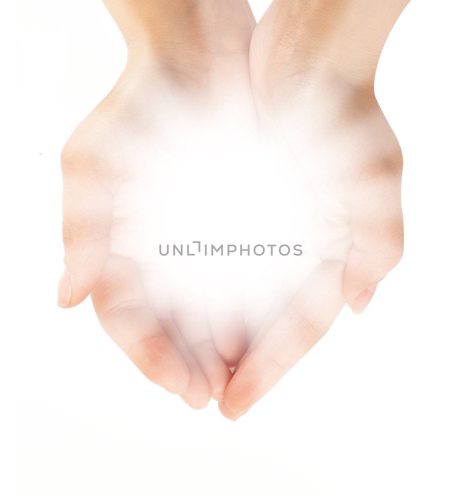 Female hands holding a brilliant shine in the dark