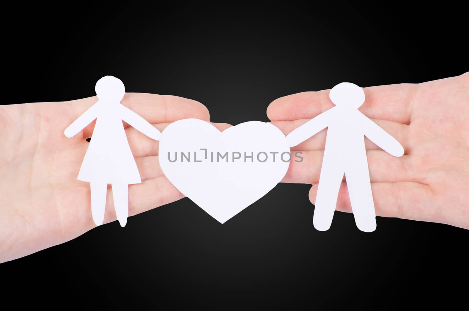 Paper family in hand with a big hearth isolated on white