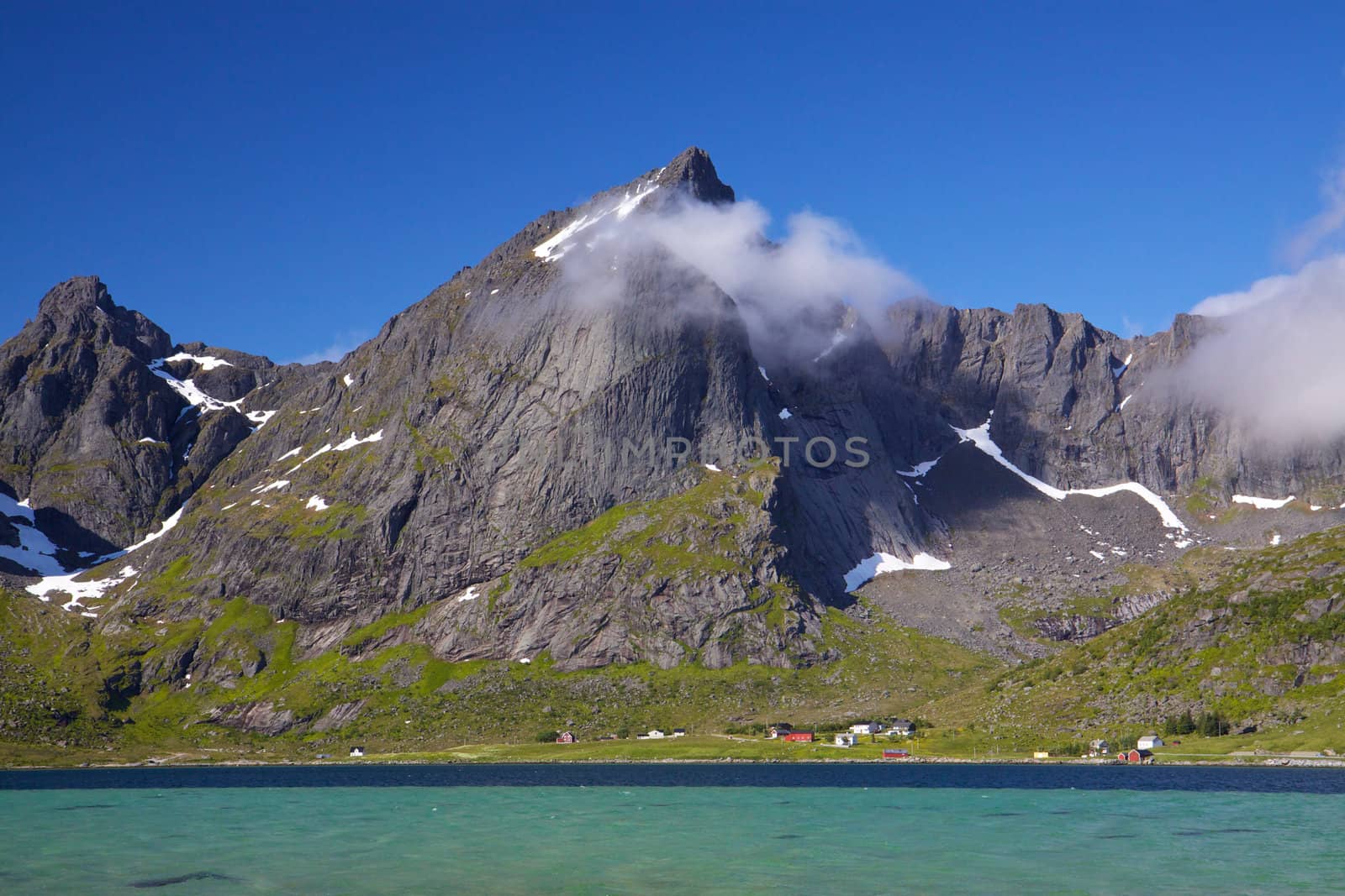 Picturesque mountain peaks towering above fjord on Lofoten islands in Norway