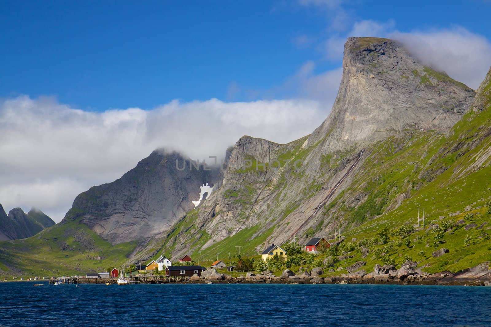 Picturesque mountain peaks towering above fjord on Lofoten islands in Norway