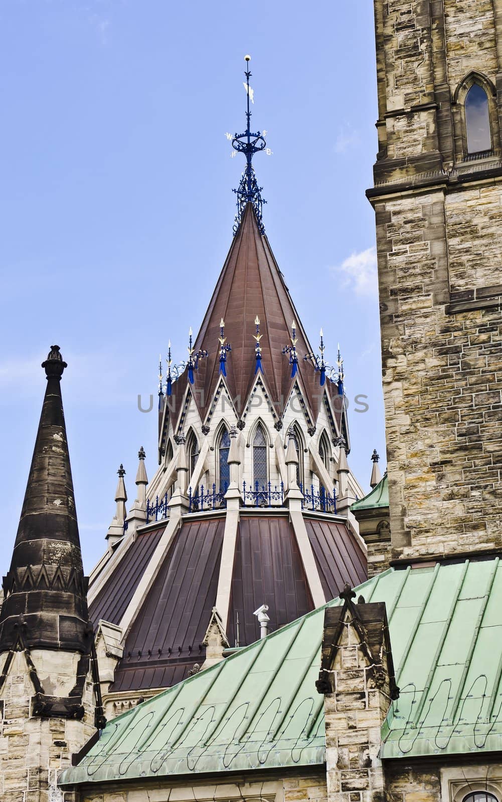 The peak of the Library of Parliament architecture with weather vane, behind the Centre block.