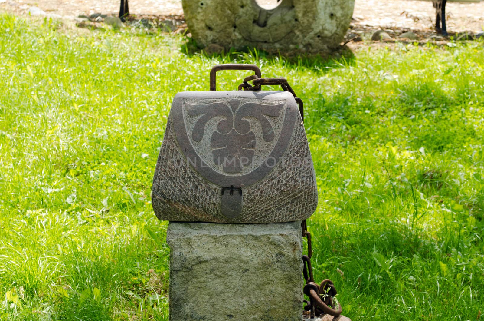 Woman handbag imitation made of stone with rusty chain.