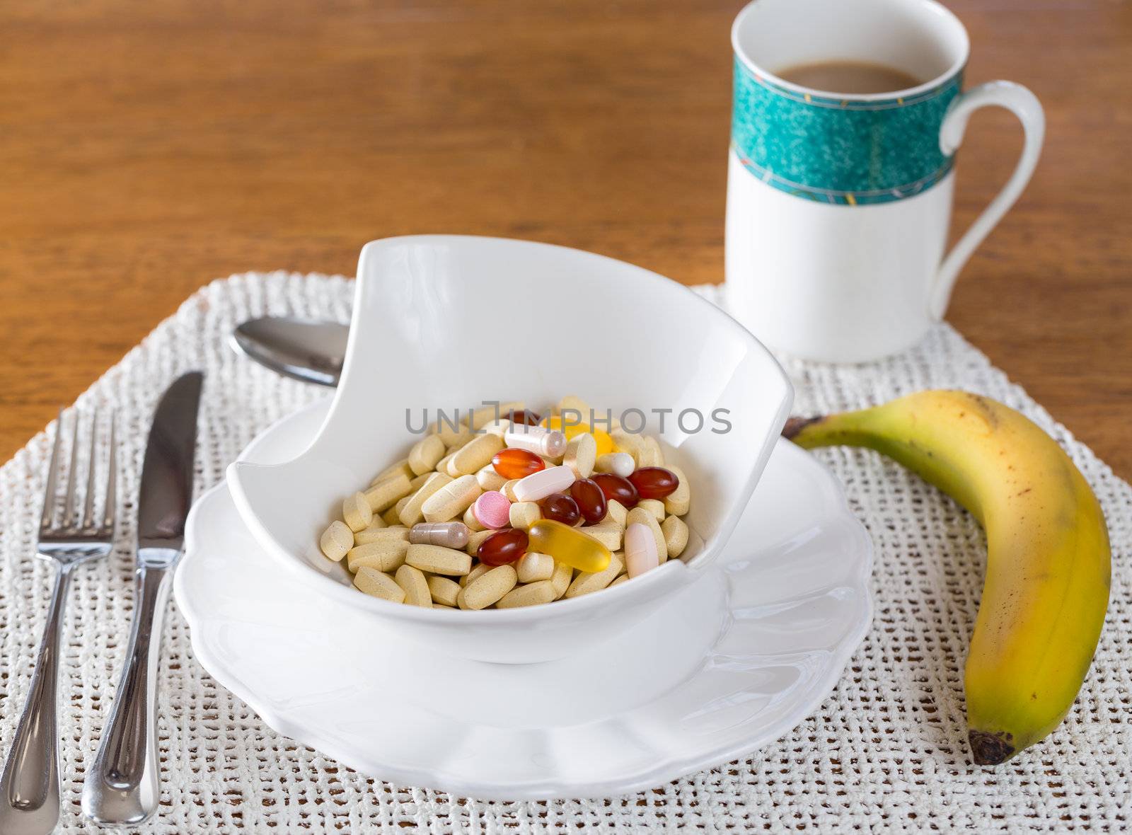 Vitamins in bowl of tablets for breakfast in kitchen