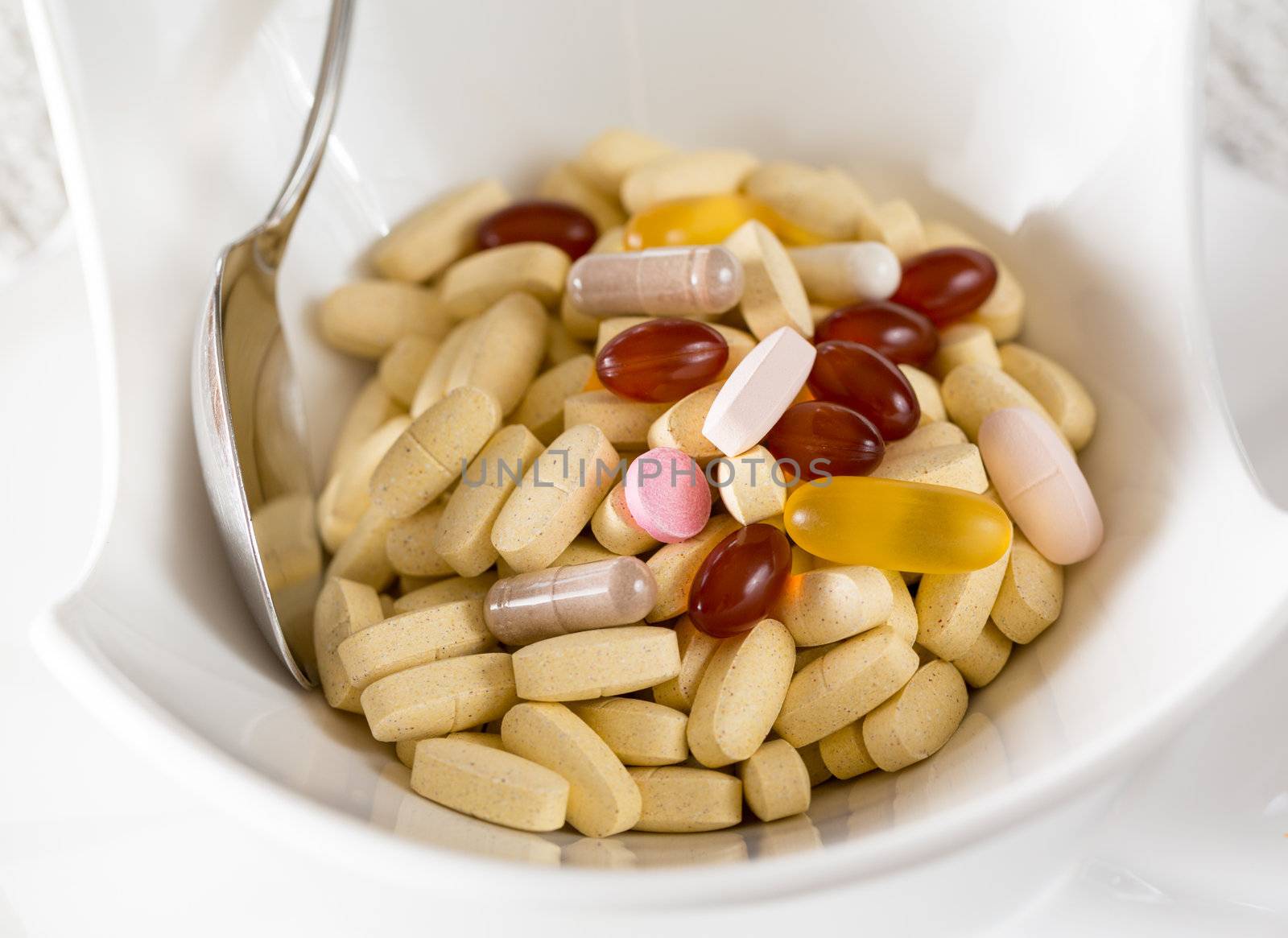 Vitamins in bowl of tablets for breakfast in kitchen