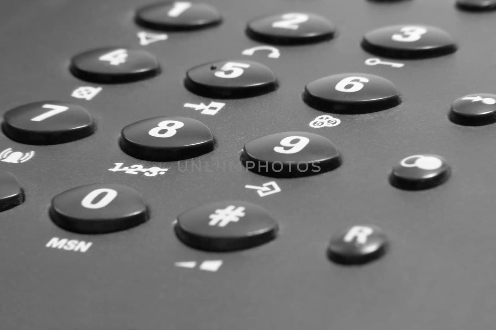dark telephone keypad closeup with white numbers