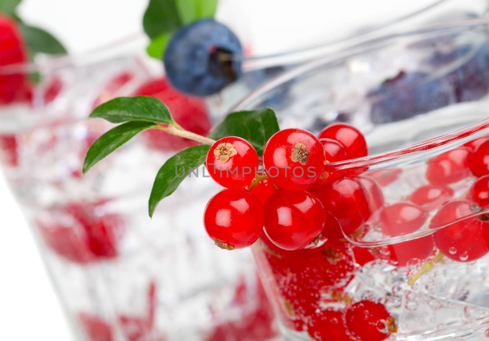 juice / cocktail with currant, blueberry and ice, isolated on white background