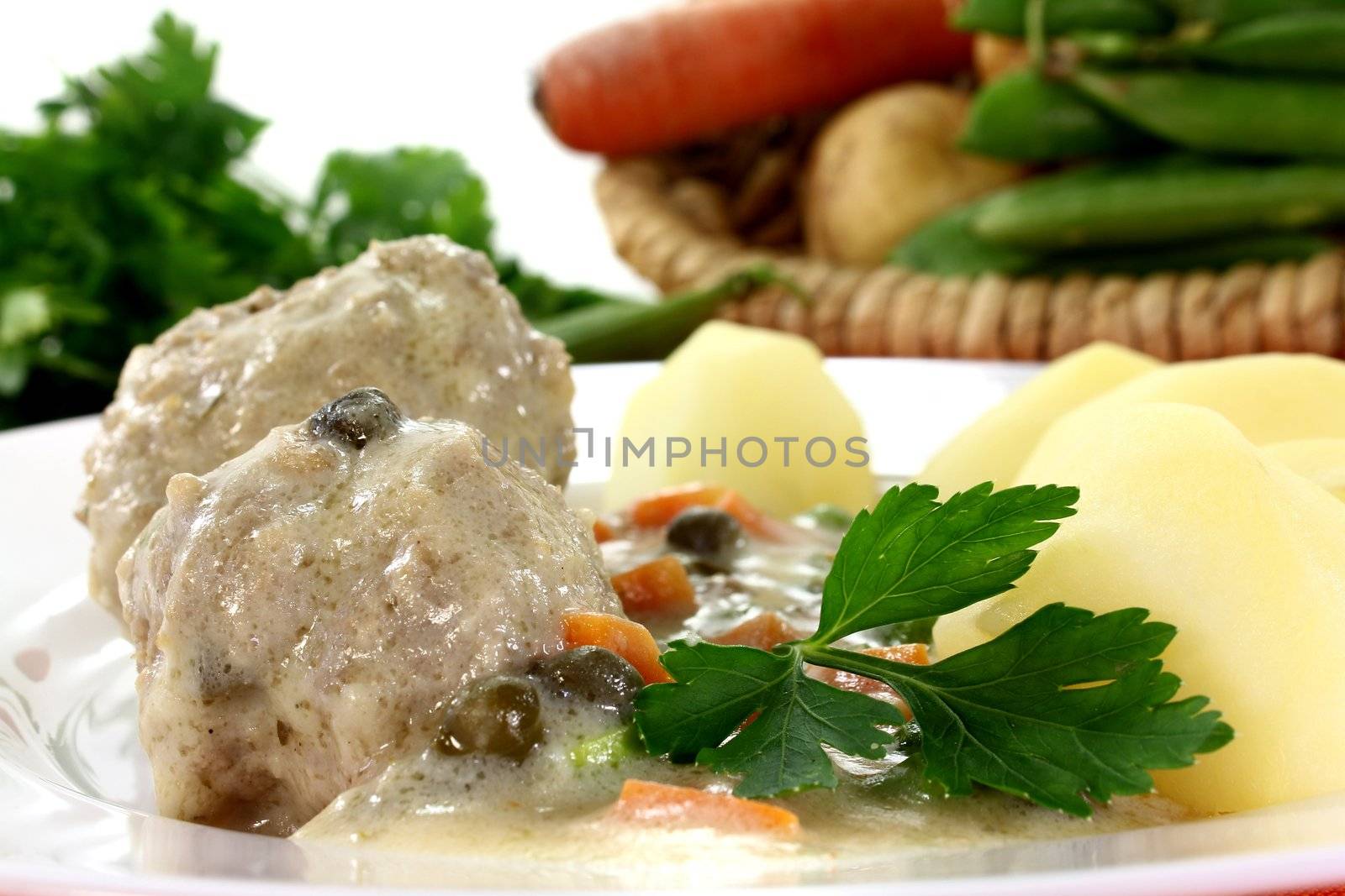 cooked meatballs with capers, peas and carrots