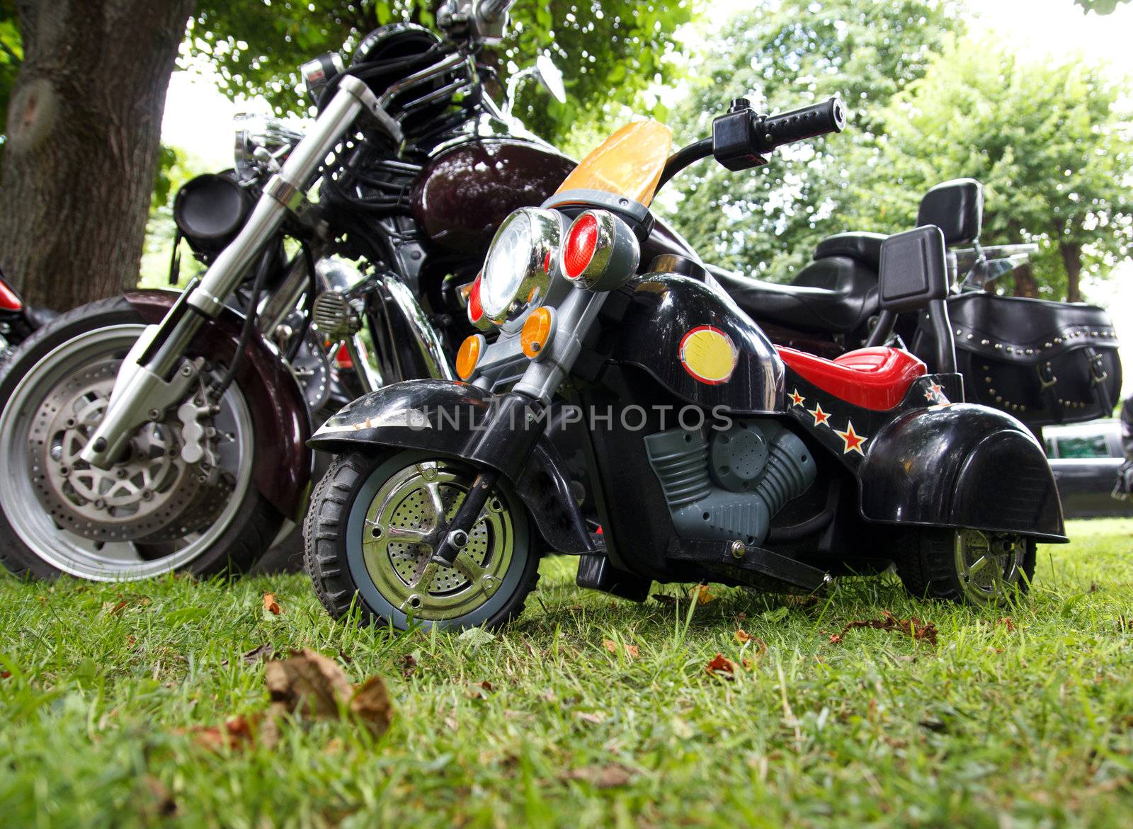 little children's electric motorcycle and a big bike