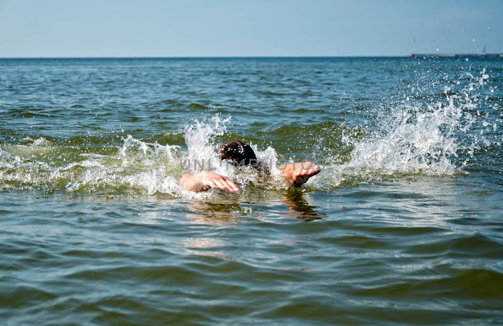 Young male swimming in the sea/ocean