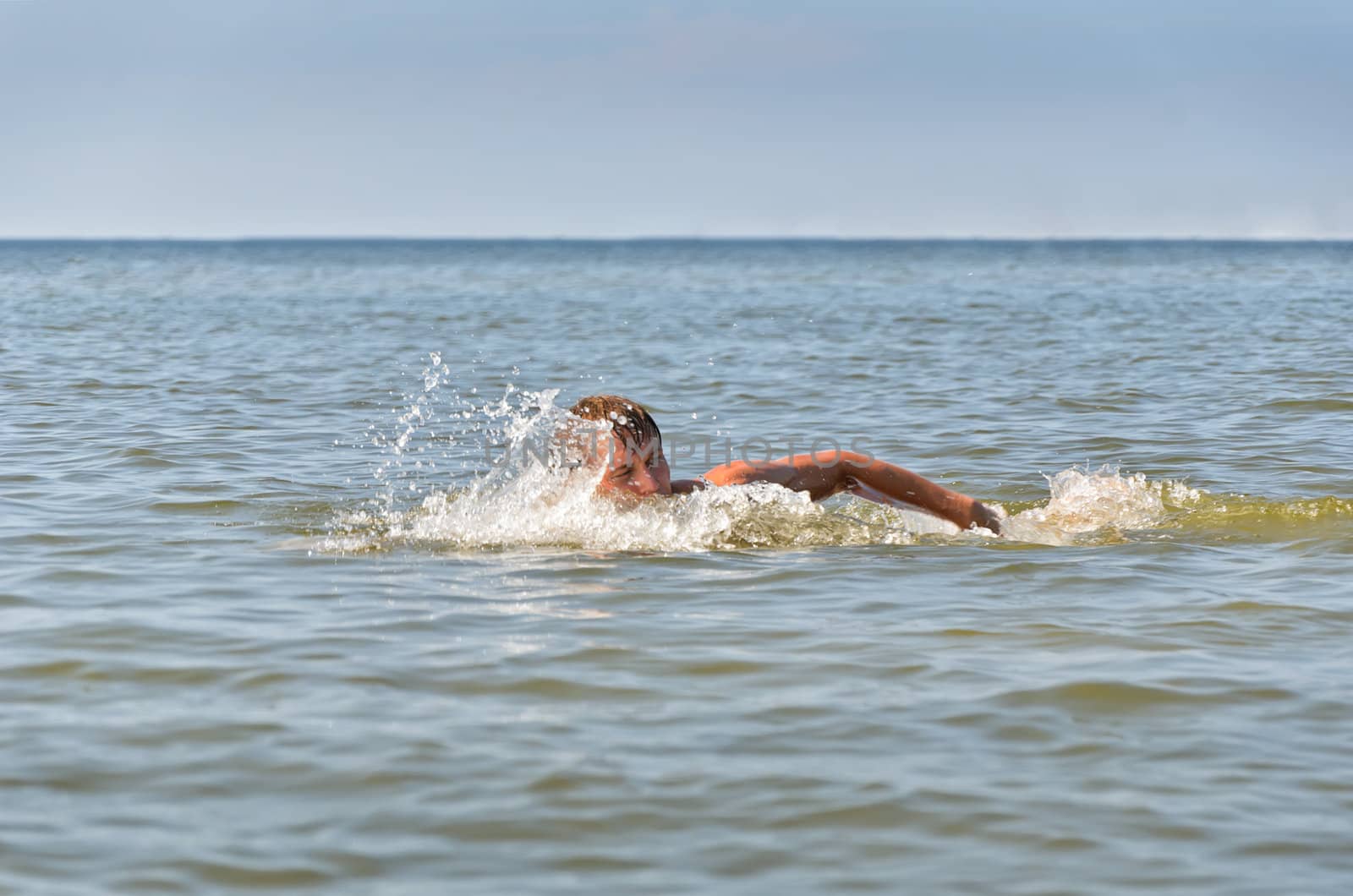 Young male swimming in the sea/ocean
