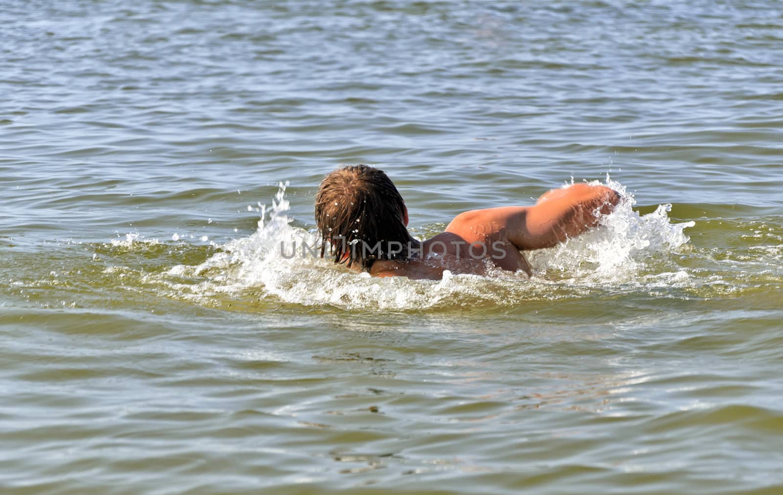 Young male swimming in the sea/ocean