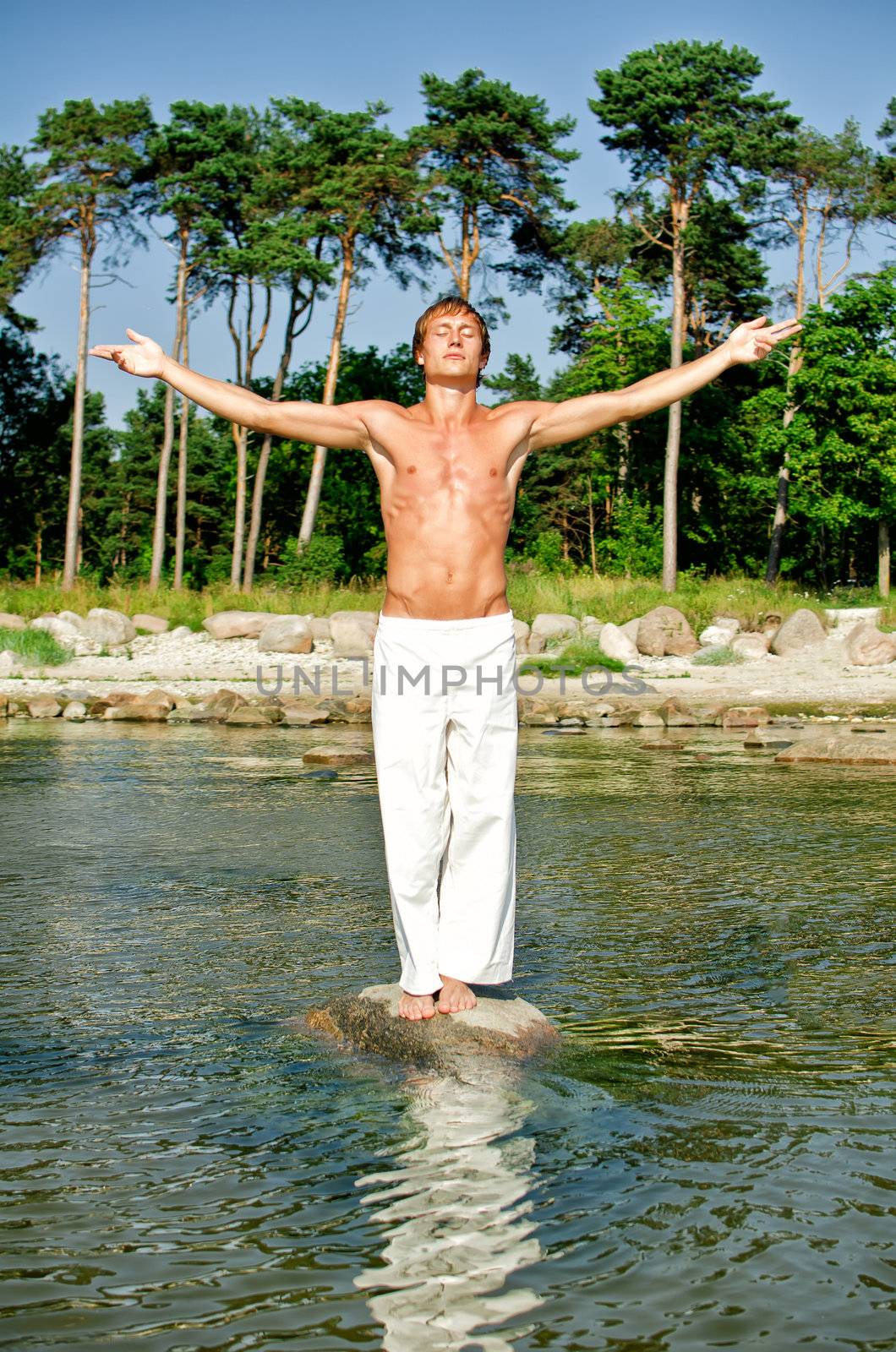 Man doing meditation exercises on the beach