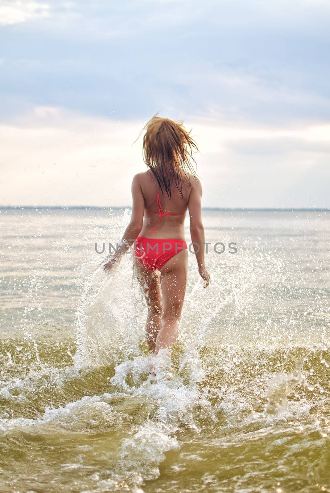 Pretty woman having fun in the sea by dmitrimaruta