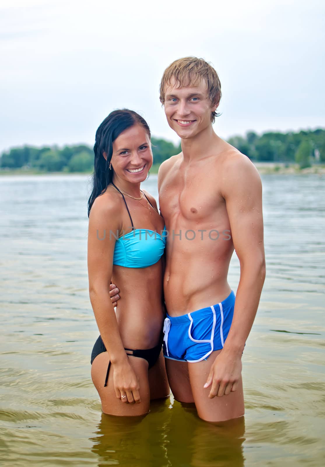 Pretty couple posing in the sea