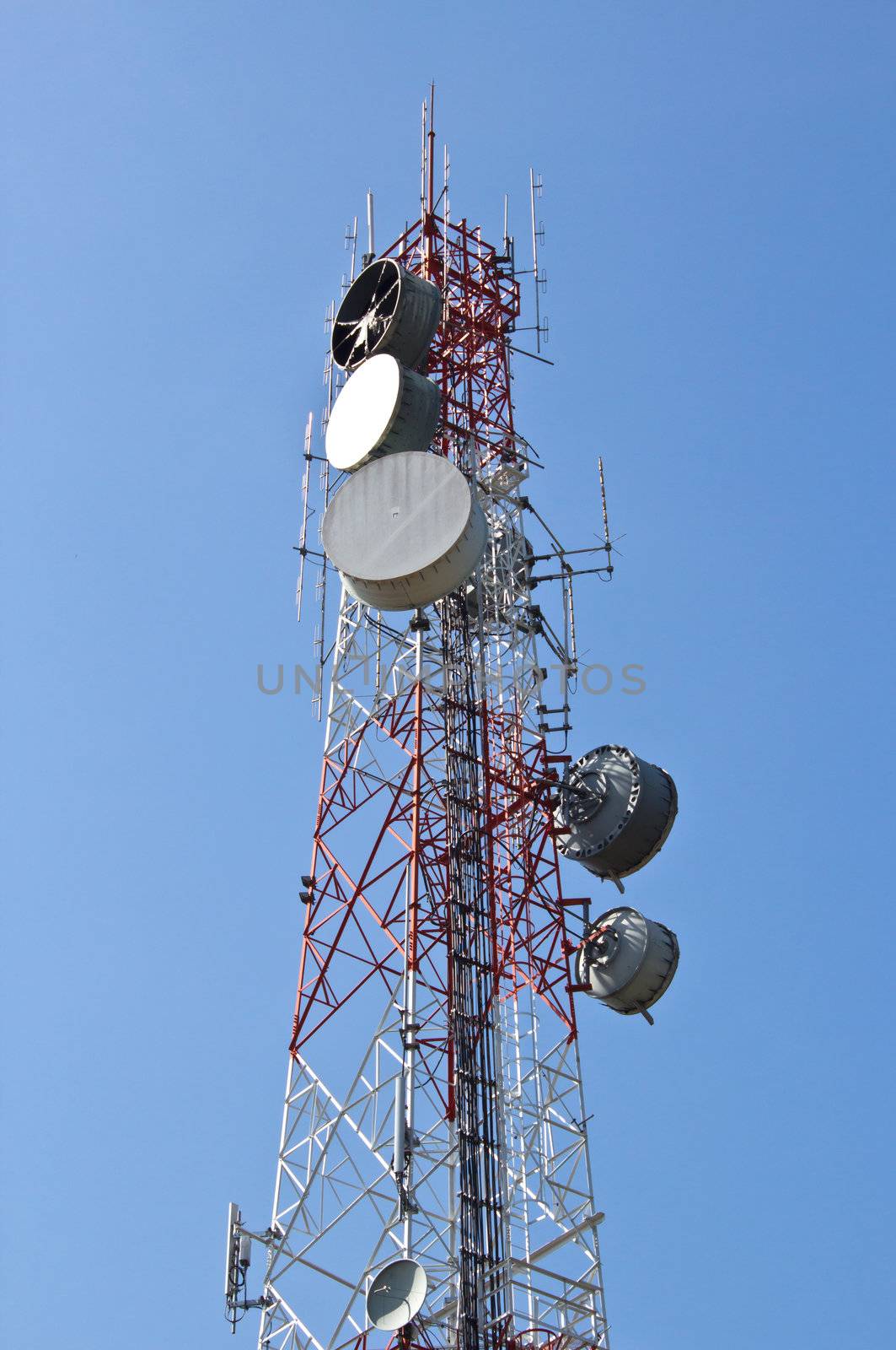 communication tower with satellite dishes and aerials