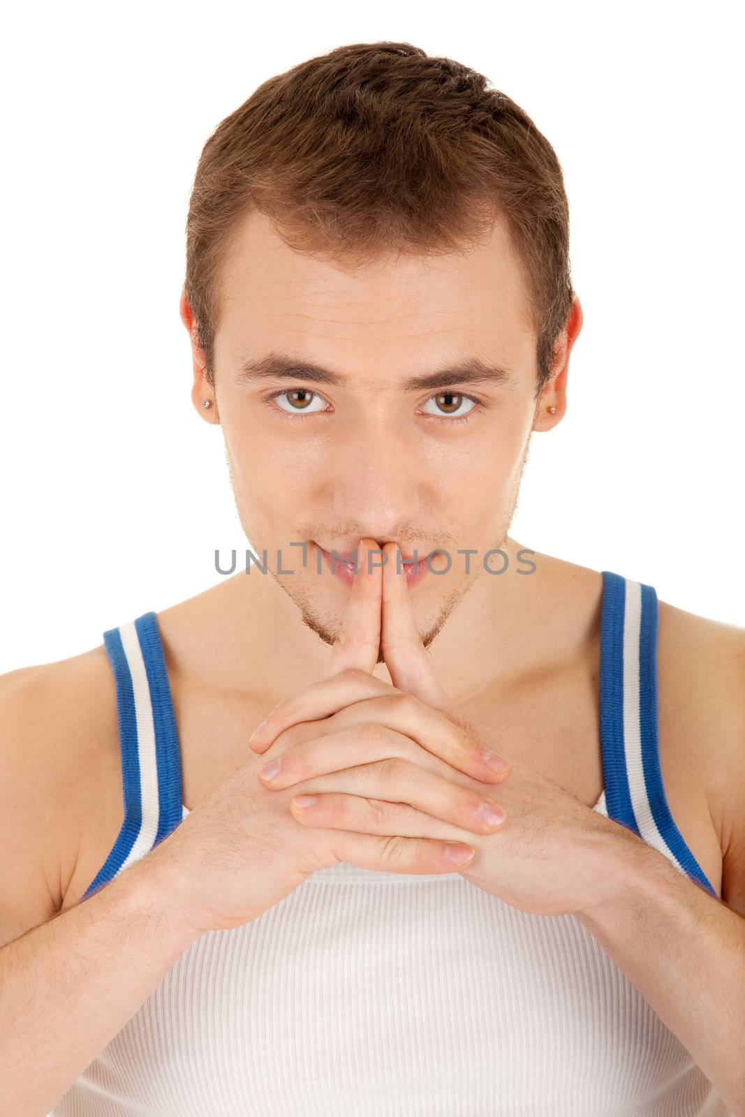 Handsome young man in T-shirt is looking to you, his hands touch lips . Isolated on white background