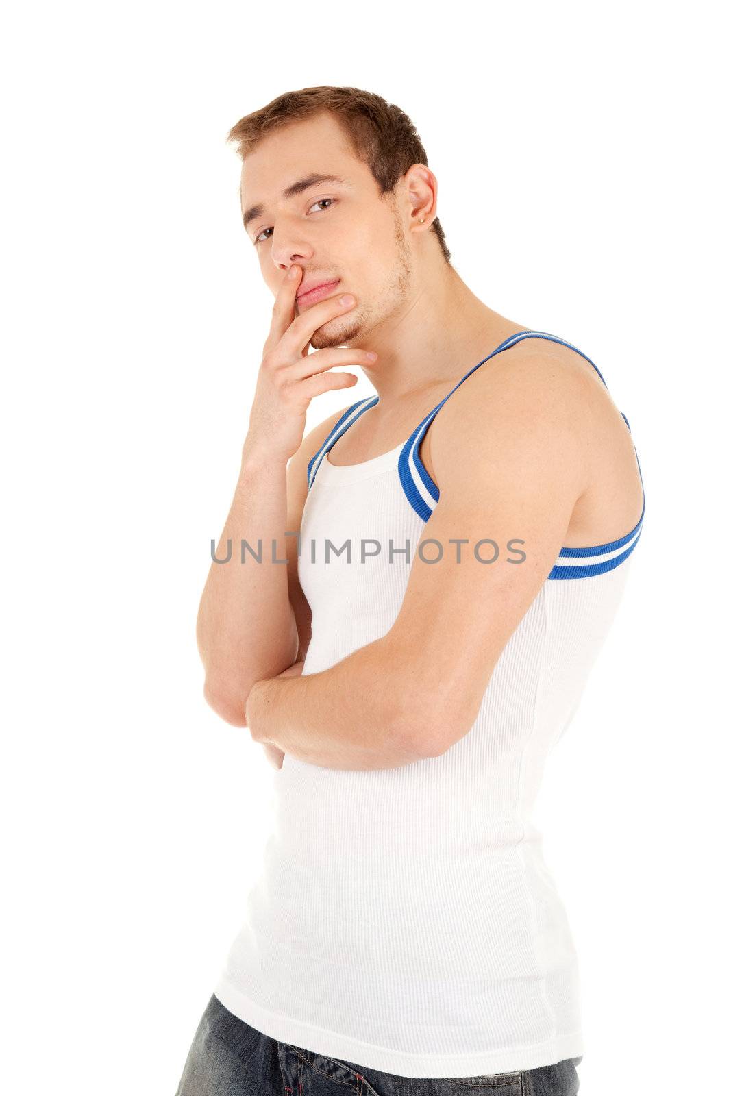 Handsome young man in T-shirt is looking to you, his right hand touches lips . Isolated on white background