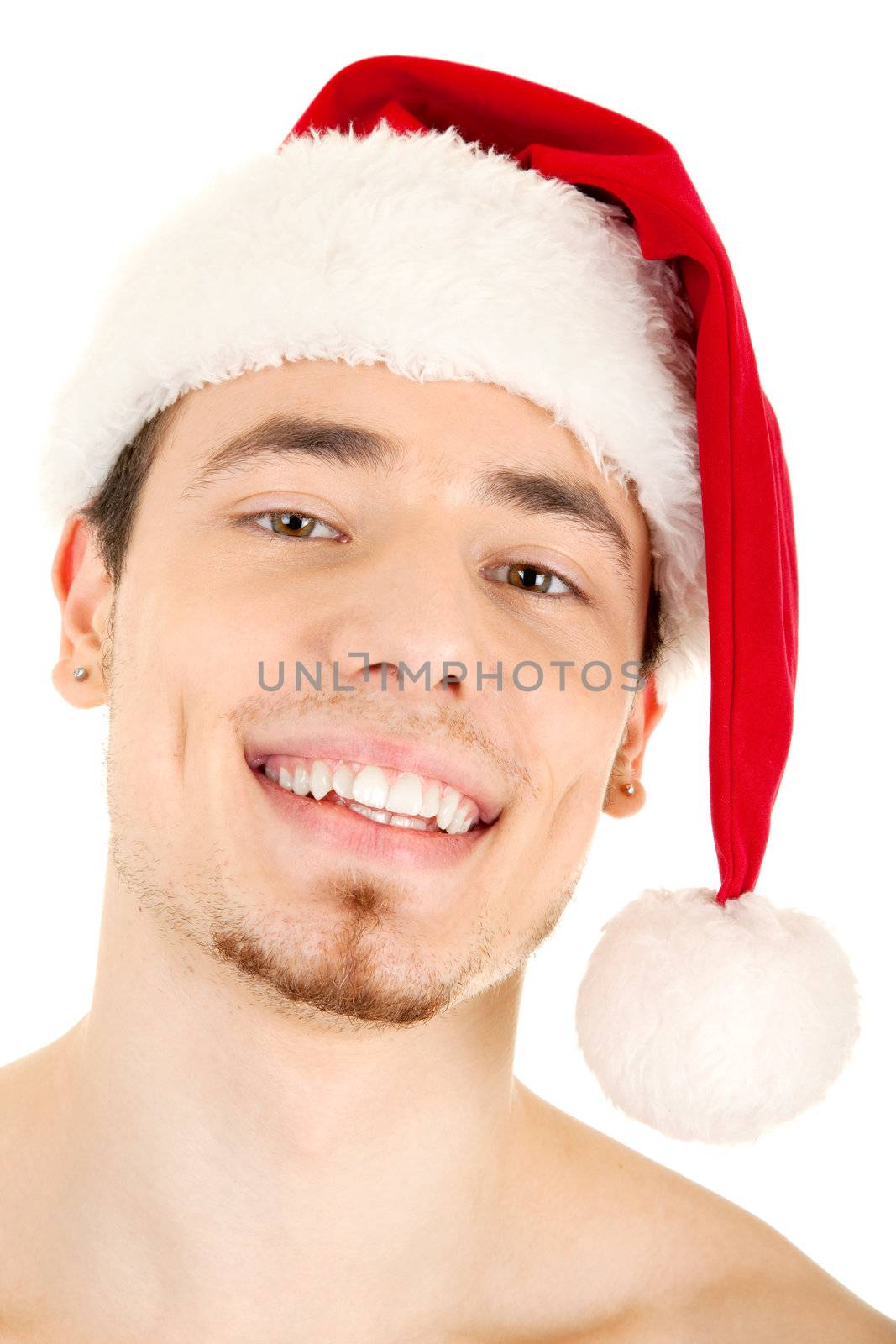 Portrait of young handsome smiling man in red Christmas hat. Isolated on white background. Focus on eyes.