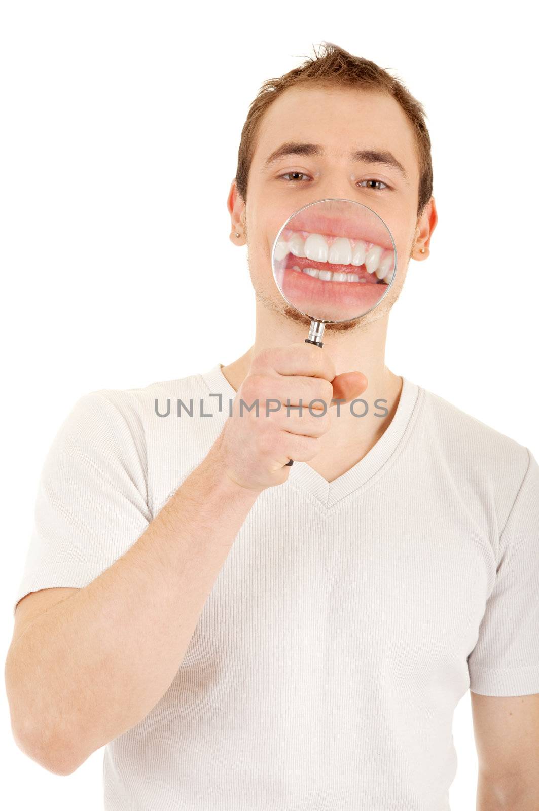 Young man in sweatshirt smile through magnifying glass. Focus on the man's face. Isolated on white background with clipping path.