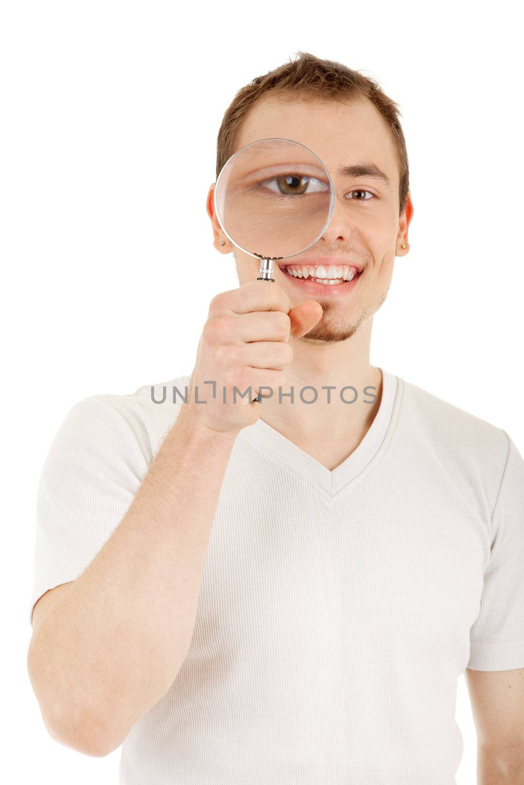 Young man in casual dress looks through magnifying glass. Focus on the man's face. Isolated on white background with clipping path.