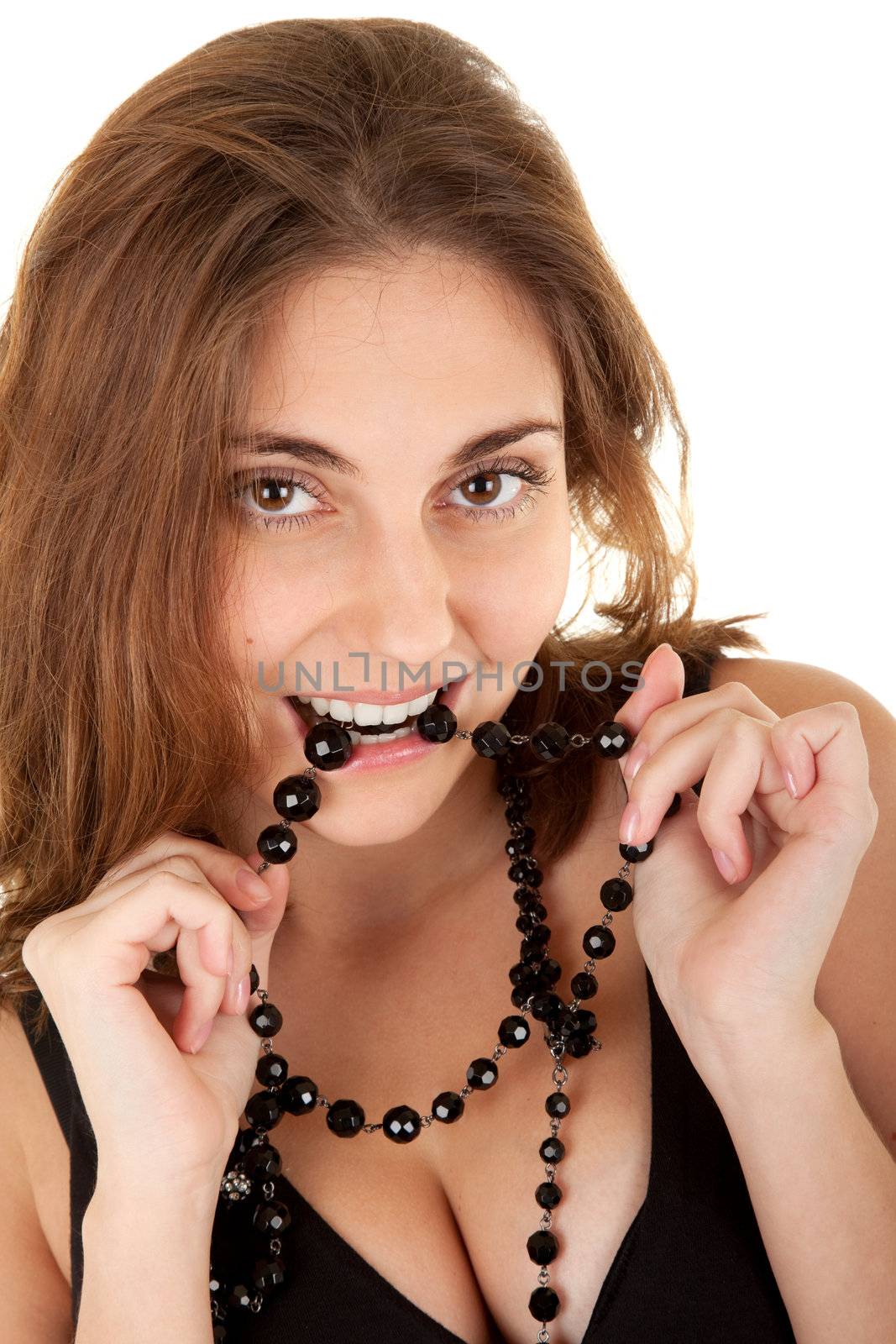 Beautiful smiling woman with white teeth is biting a black necklake