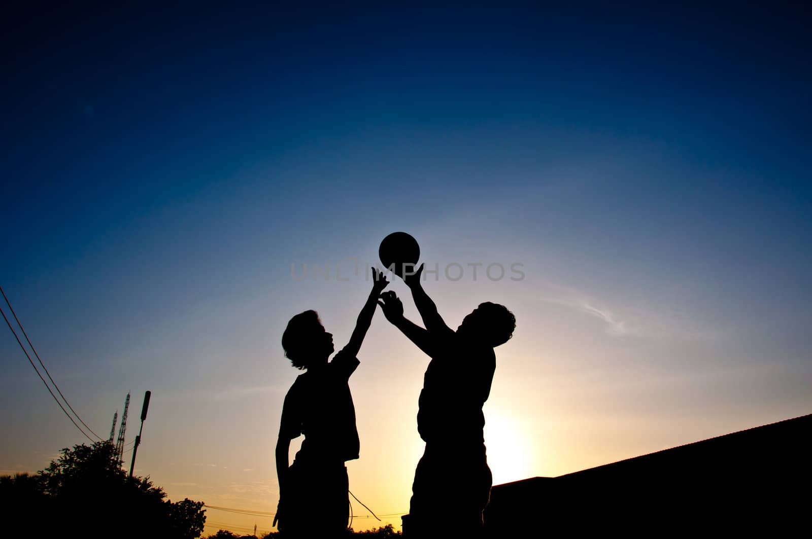 silhouette of man playing basketball