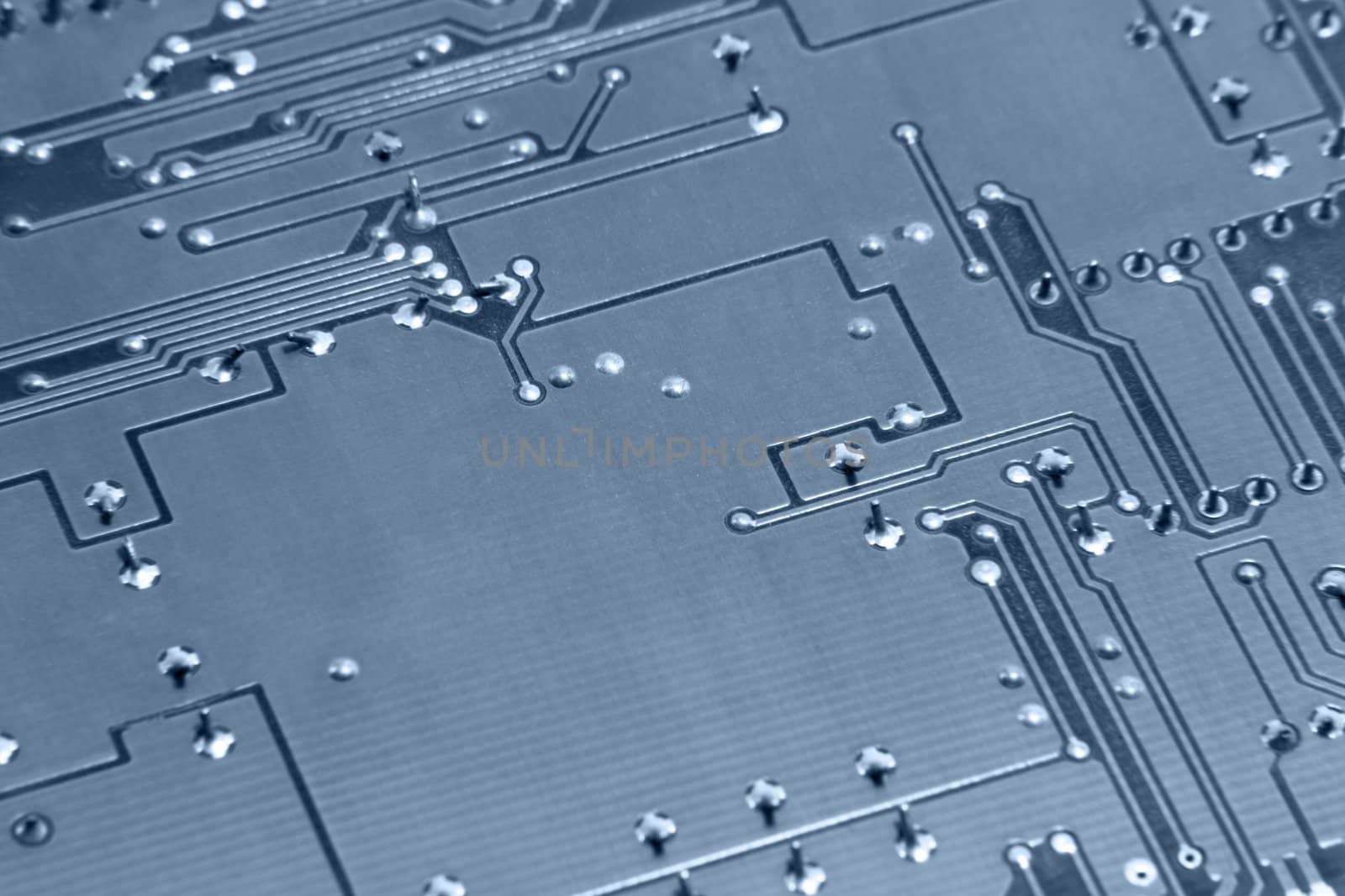 blue toned abstract detail of a circuit board backside