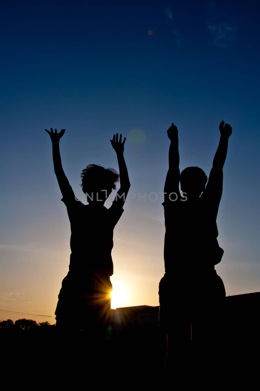 silhouette of man jumping for victory