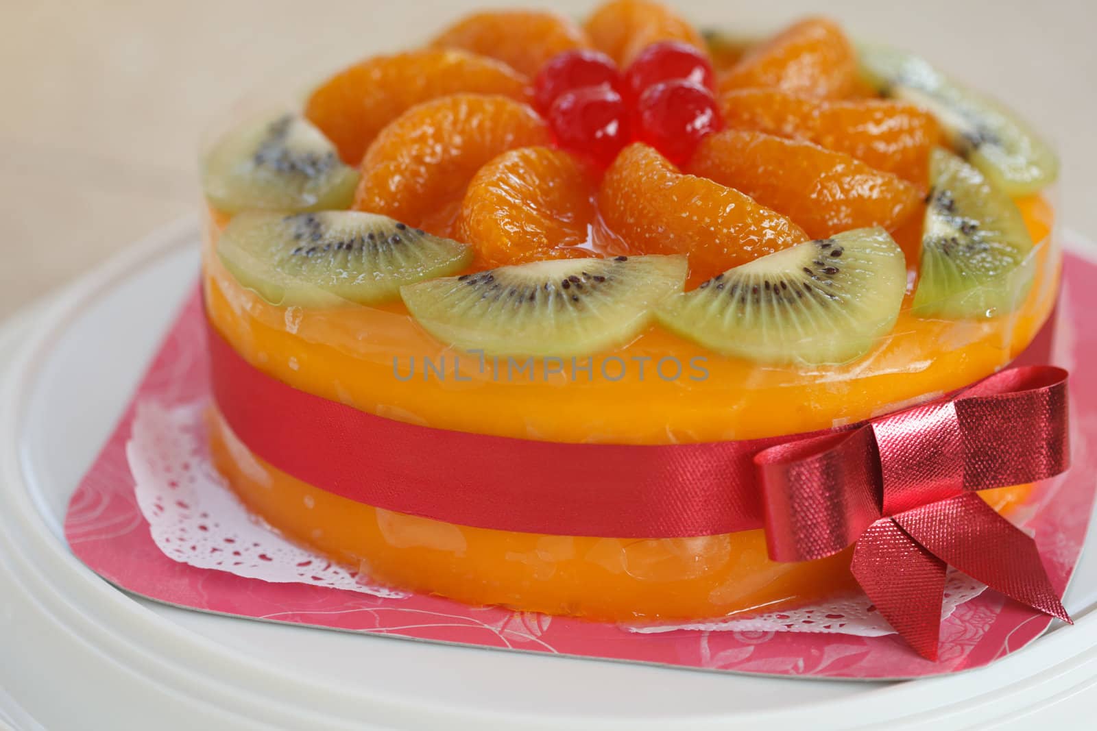 mixed fruit with orange jam cake and pink ribbon