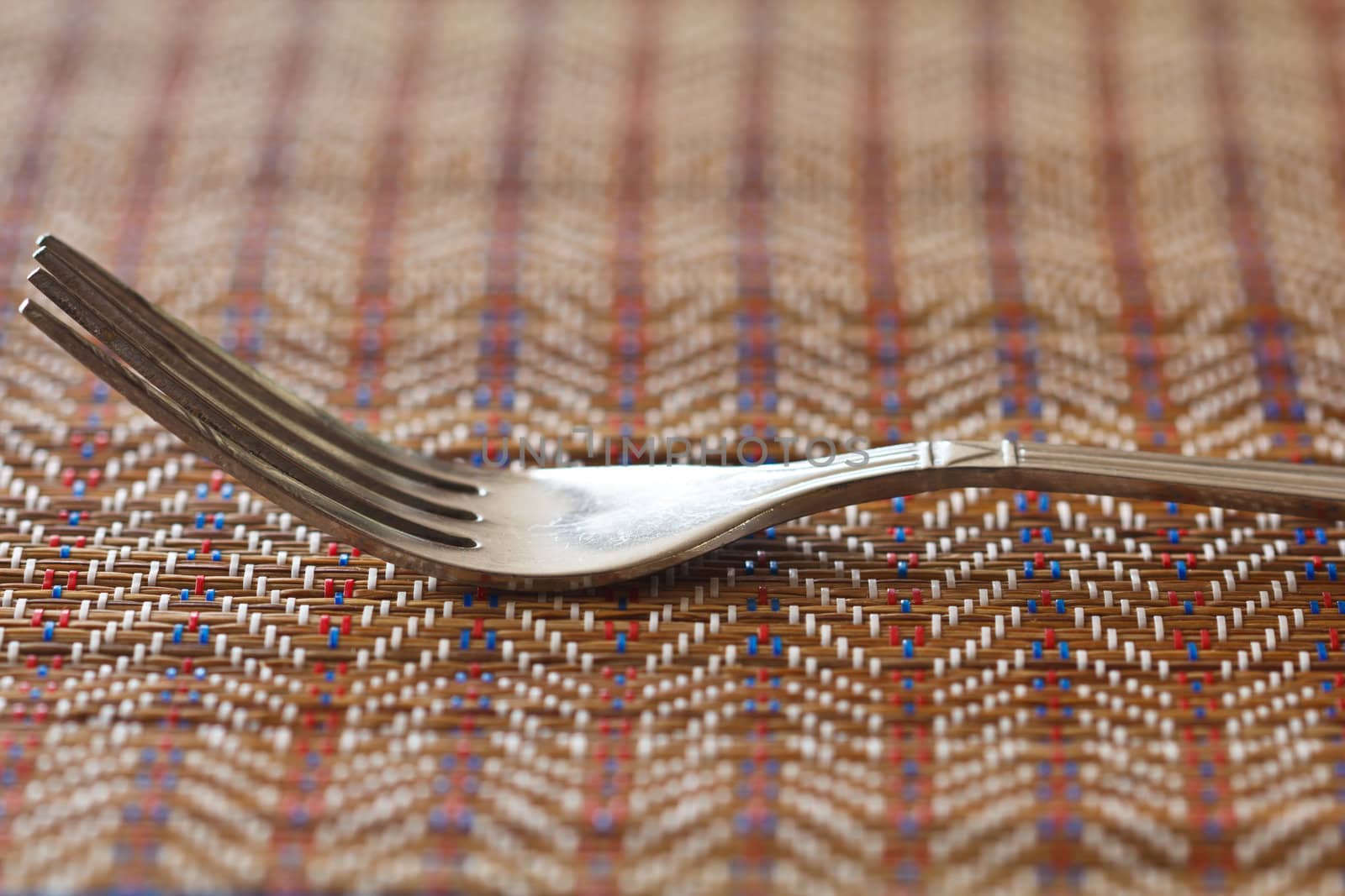 A fork on brown napkin