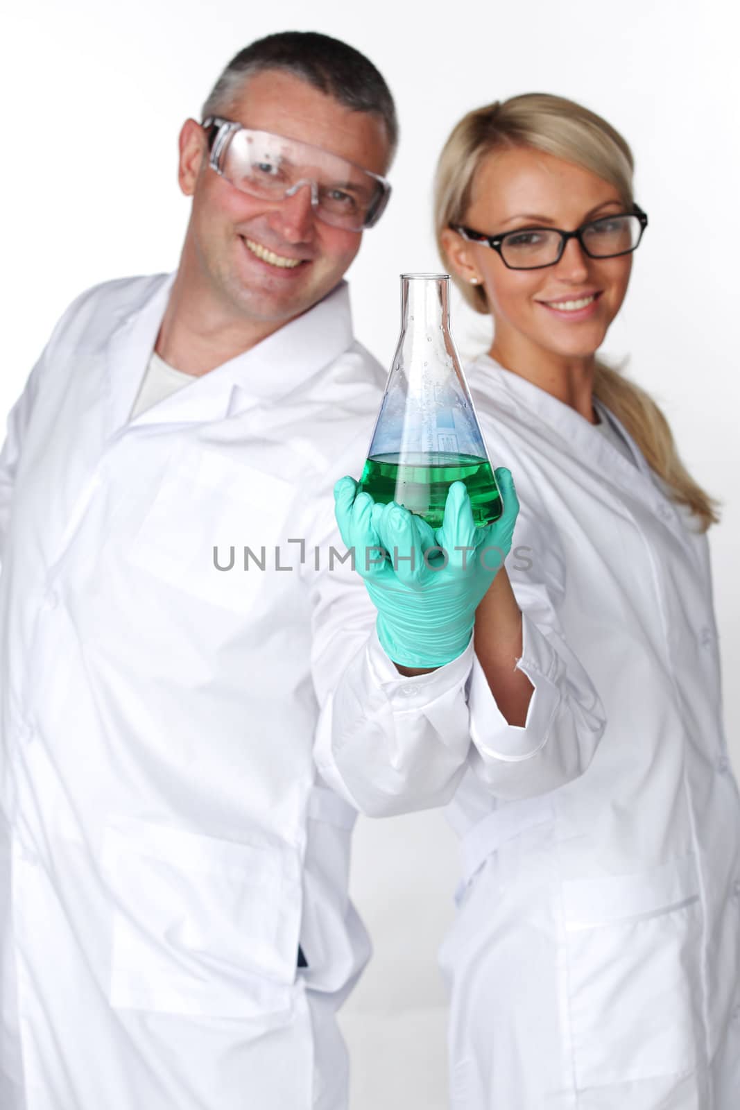  researchers holding a secret green chemical substance