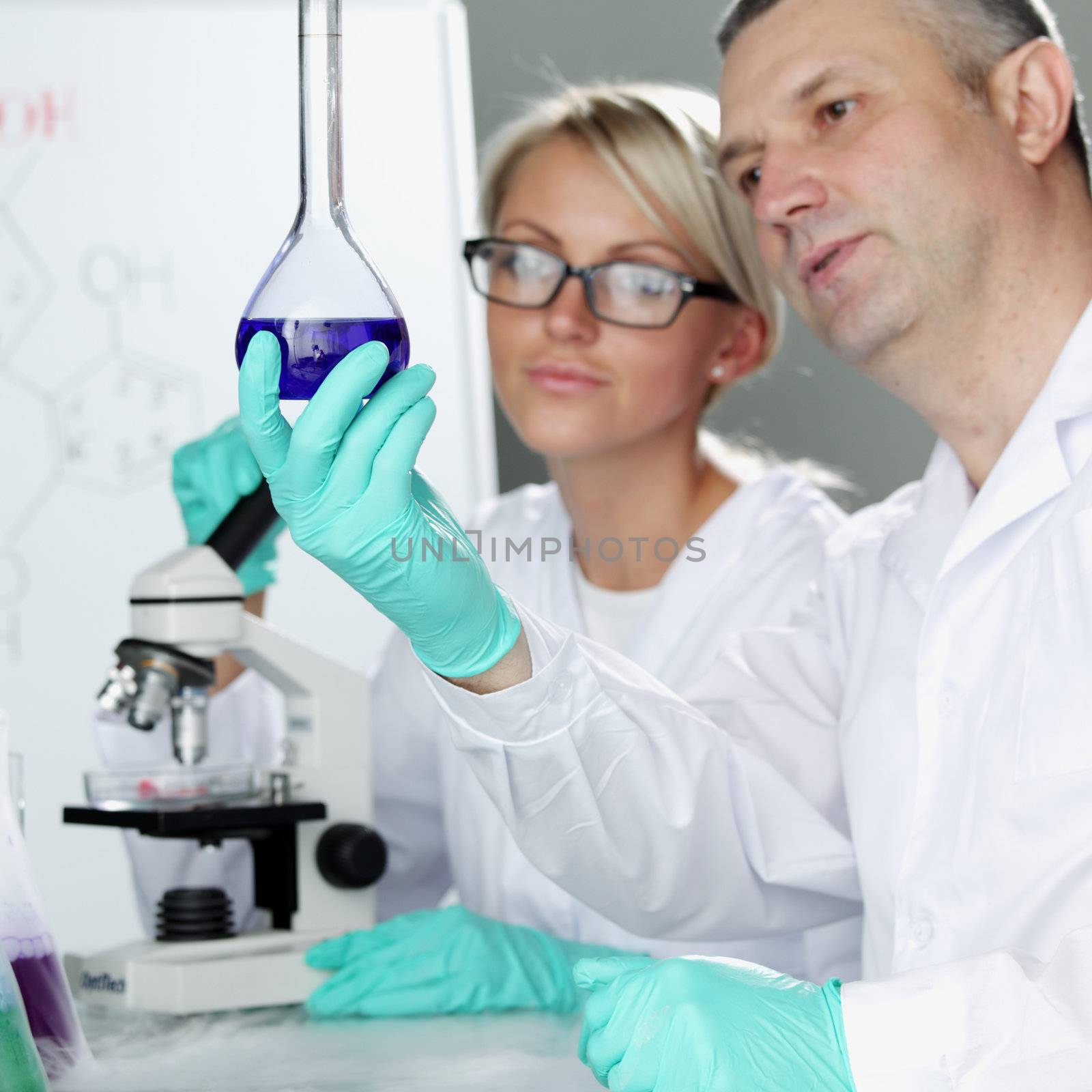 two scientist in chemical lab conducting experiments