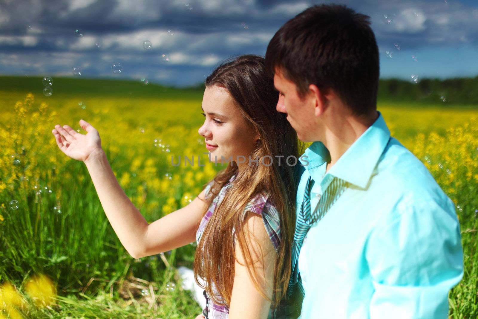 lovers hug on yellow flower field