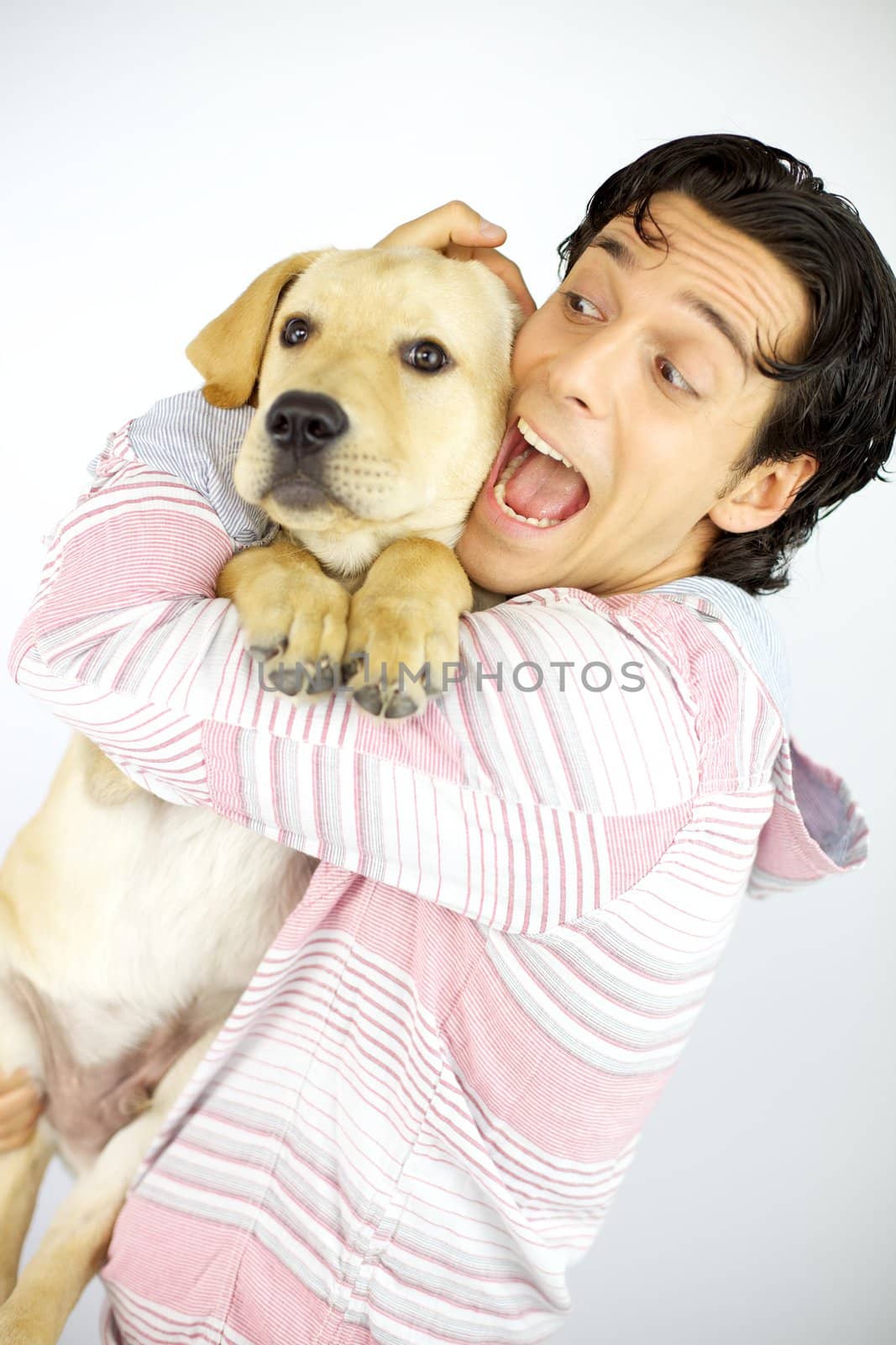 happy young male model hugging puppy labrador dog 