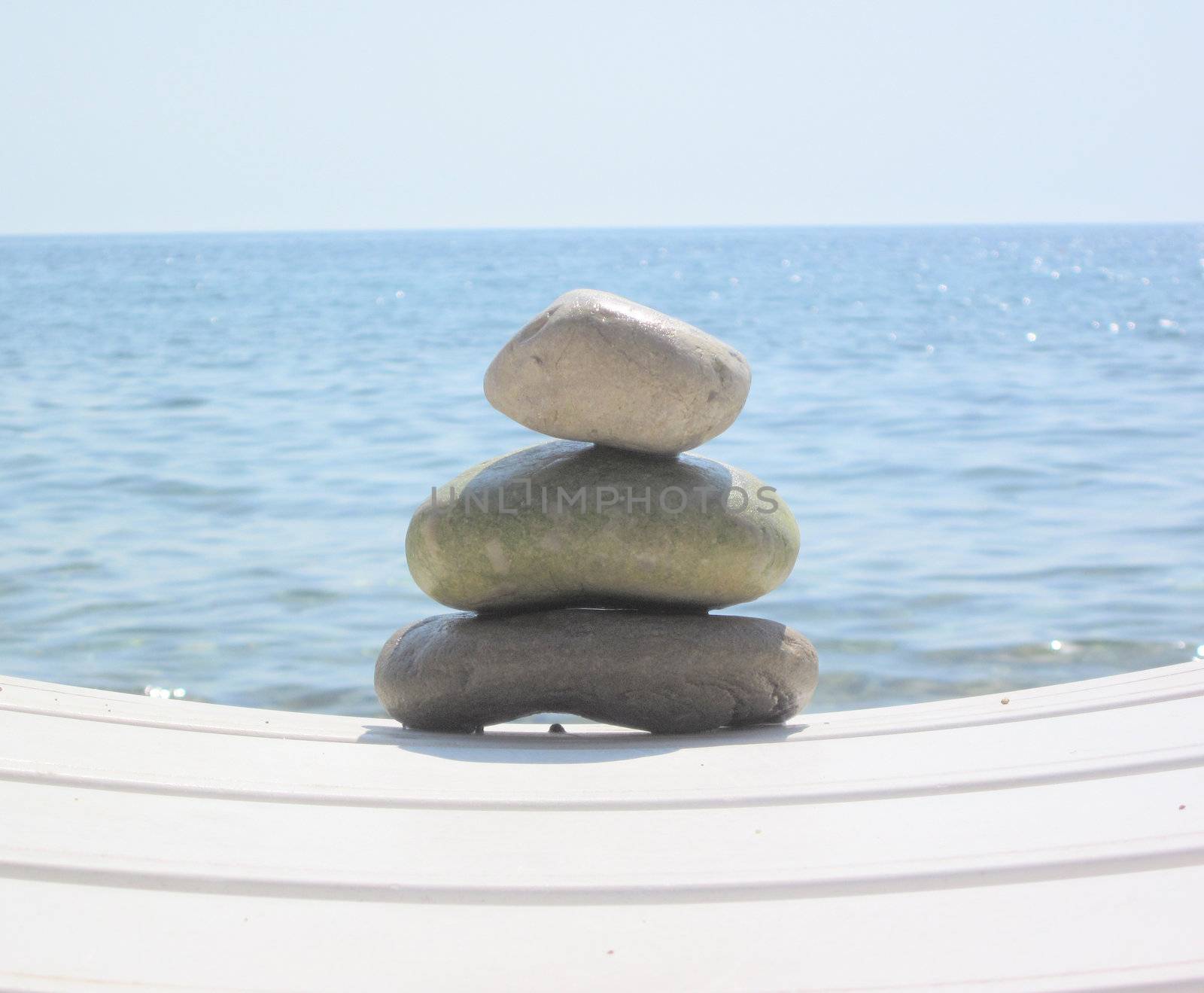 The stack of pebble stones in zen concept  on chaise longues  by svtrotof