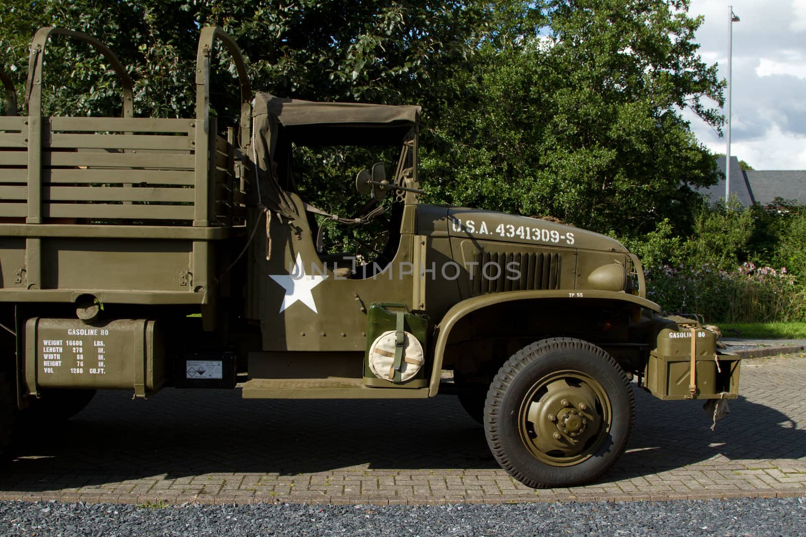 A vintage world war 2 American truck front end driver's cab with engine hood.