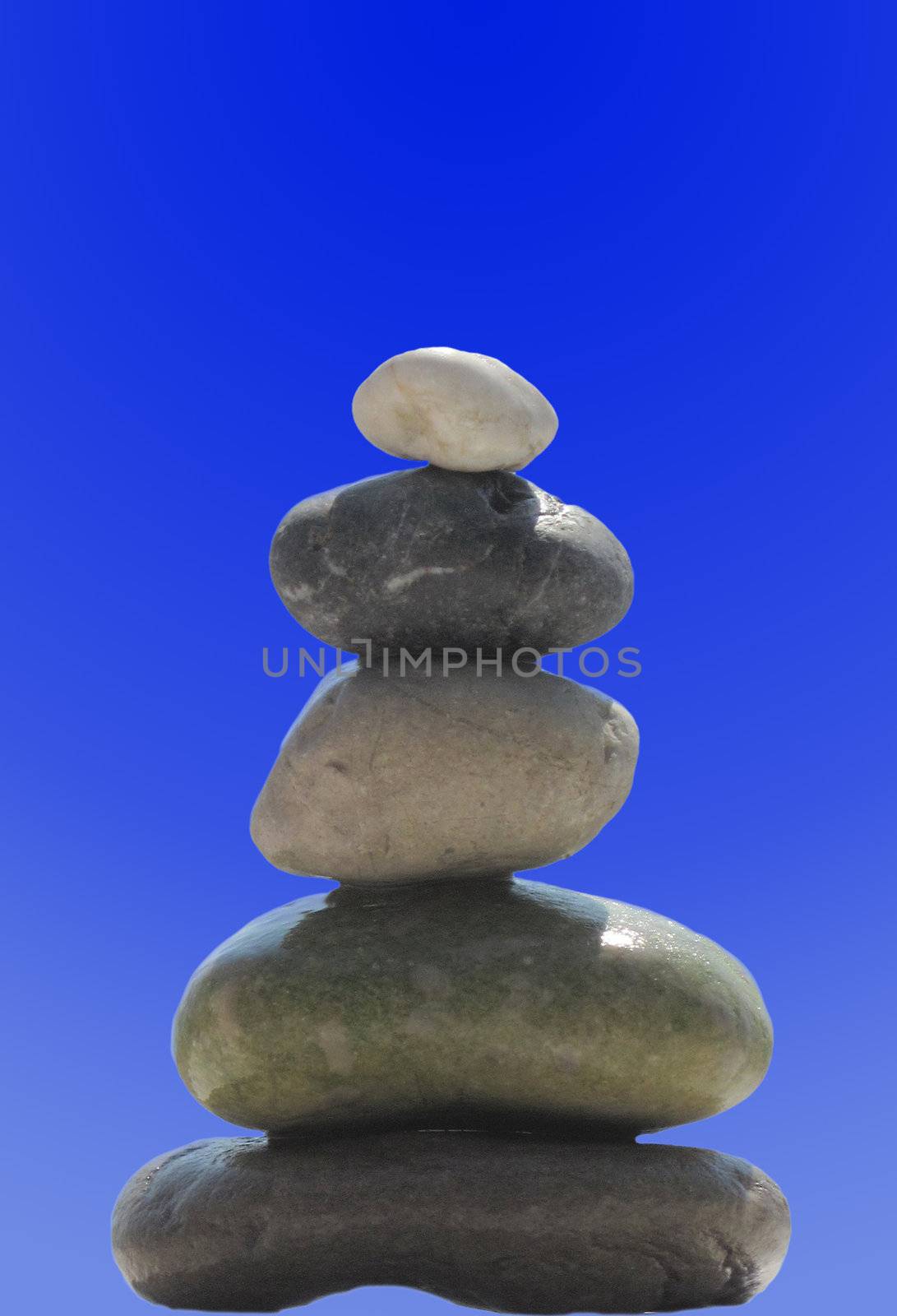 The stack of pebble stones in zen concept on blue